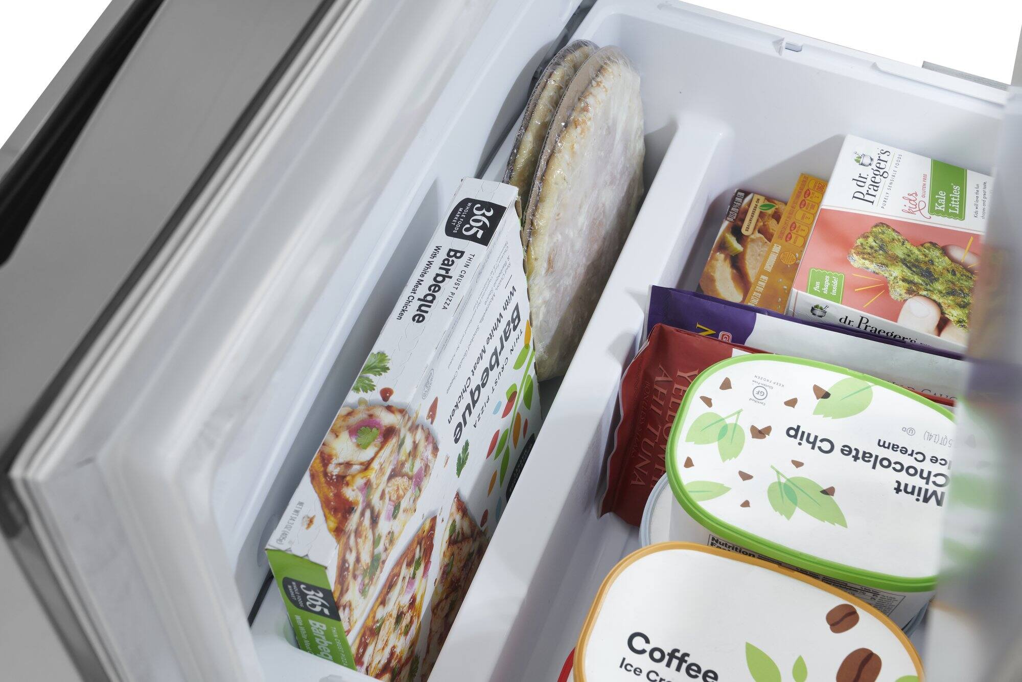 The image shows a refrigerator with a variety of food items inside. There are two pizzas, one in the top left section and the other in the top right section. There are also several packages of ice cream, with one in the bottom left section, another in the bottom right section, and the third one in the middle right section. Additionally, there are two bowls, one in the top right corner and the other in the bottom left corner. The refrigerator is filled with a diverse selection of food items, including pizzas and ice cream.