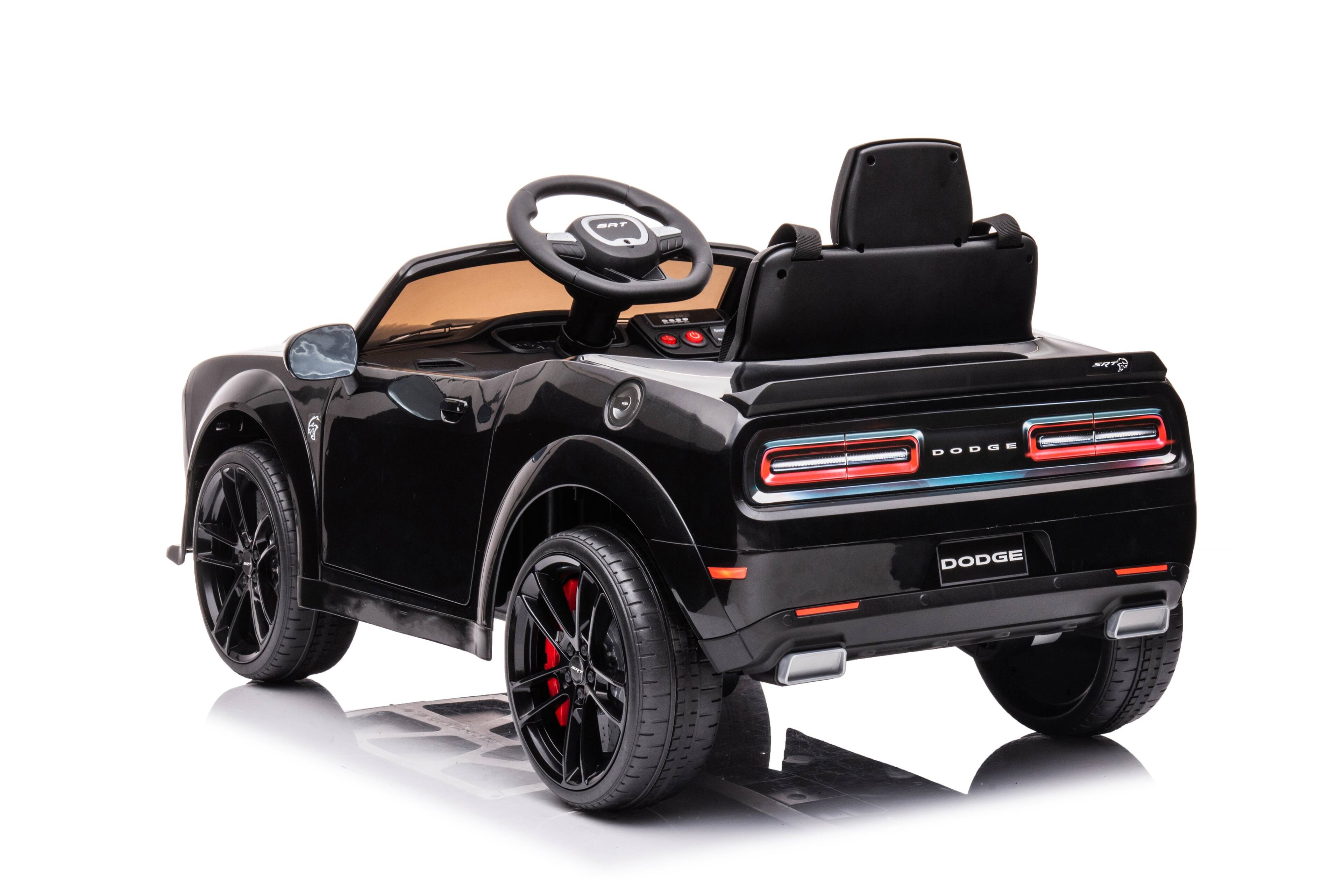 The text on the image reads "TAS. Sxde T 6 DODGE DODGE." This text is likely related to the toy car, as it could be a brand or model name. However, it is not clear what the text means or refers to without additional context.