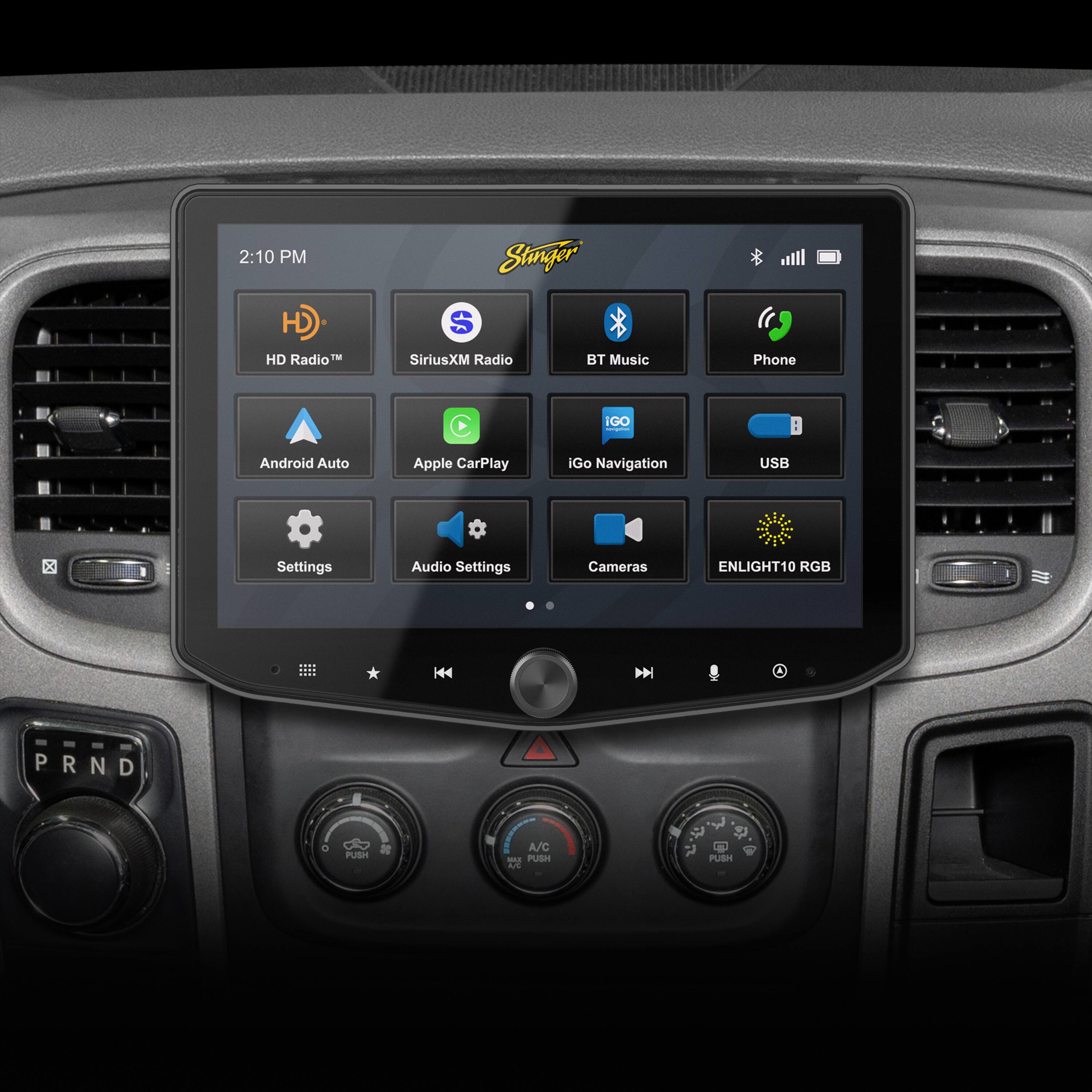 The text on the image is grouped and corrected as follows:

2:10 PM Stinger HD S HD Radio SiriusXM Radio BT Music Phone IGO Android Auto Apple CarPlay iGo Navigation USB C Settings Audio Settings Cameras ENLIGHT10 RGB H44 DN PRND P R N D . PUSH A/C - PUSH AE 2 $ PUSH