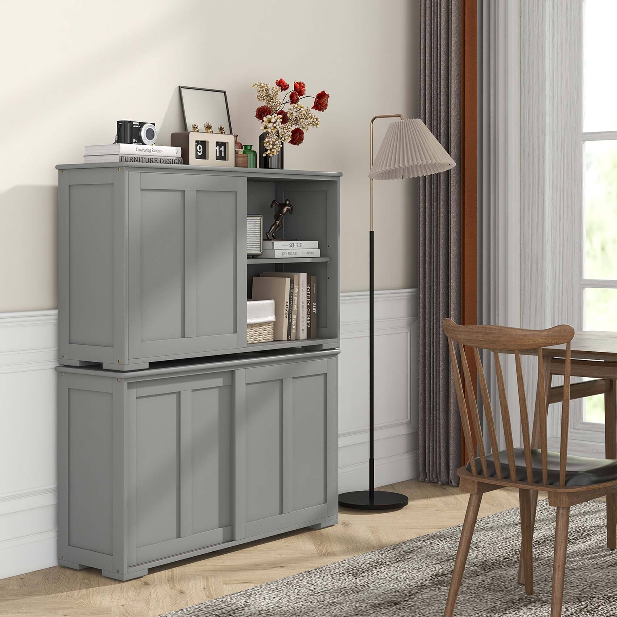 The image features a room with a wooden table and a chair. There is a bookshelf in the room, which has a lamp on it. The bookshelf is filled with books and decorative items, such as a vase with flowers. The room also has a window, providing natural light to the space. The overall design of the room appears to be modern and well-organized.