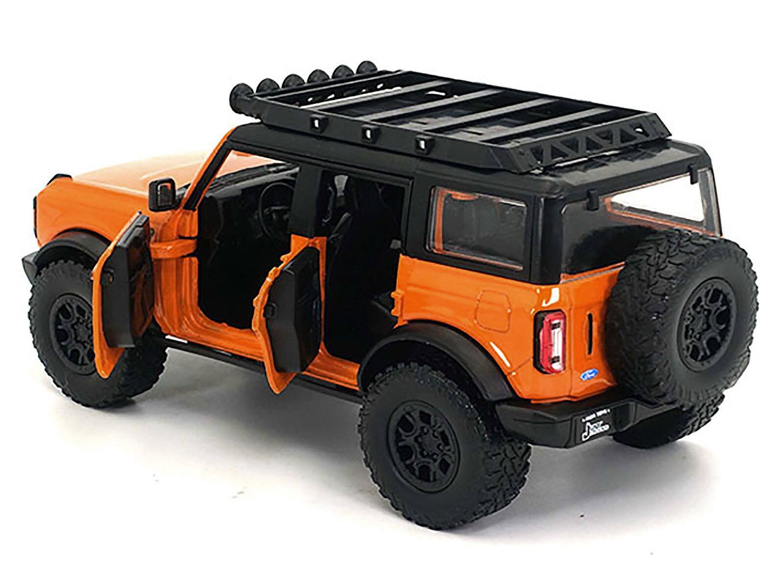 Angle. Jada - 2021 Ford Bronco Orange with Black Stripes and Roof Rack "Just Trucks" Series 1/24 Diecast Model Car by Jada - Orange With Black.