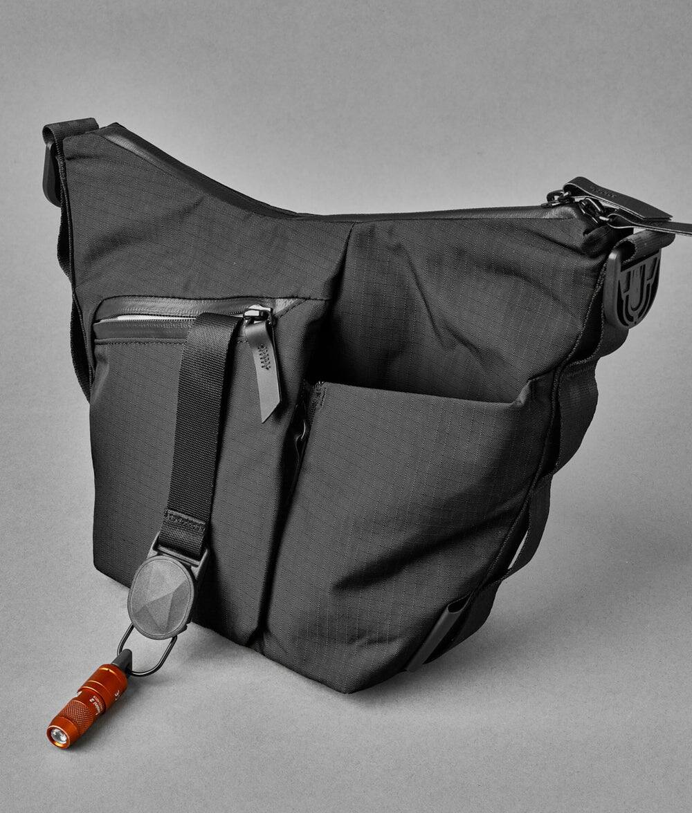 Alt View 4. ALPAKA - Flow Satchel Mini 2L Crossbody Bag, Water Resistant Shoulder Bag, Expandable Bottle Pocket, YKK Zippers - Black Axoflux 210D.