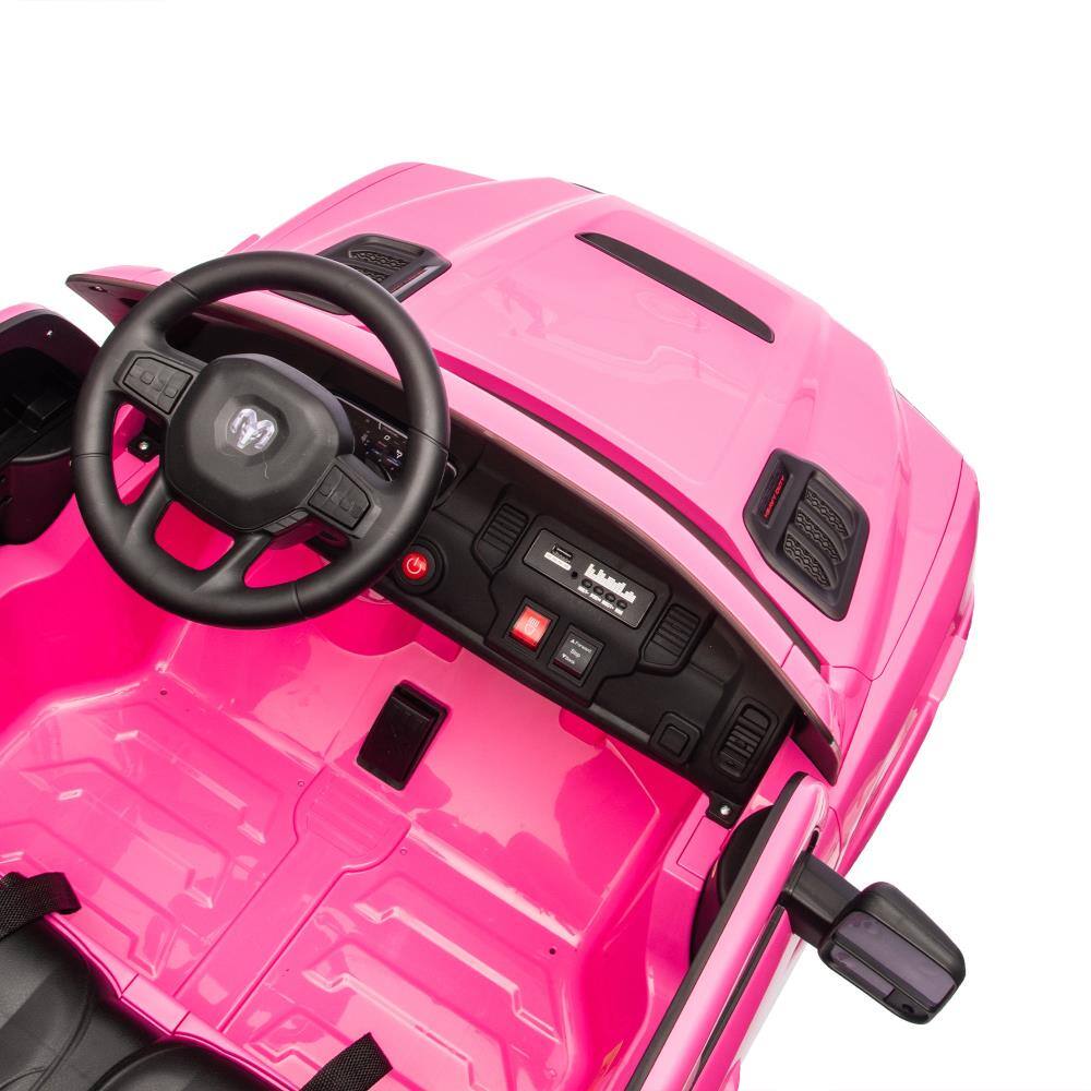 The text on the image appears to be a mix of symbols and letters that are not clearly legible. However, based on the context of the image, which shows a pink toy car, the text might be related to the brand or model of the car. Here is a possible interpretation:

- "M" (on the steering wheel)
- "GOOL" (on the dashboard)

The rest of the text seems to be part of the car's design or controls and is not clearly readable. If you have more context or a clearer image, I might be able to help further!