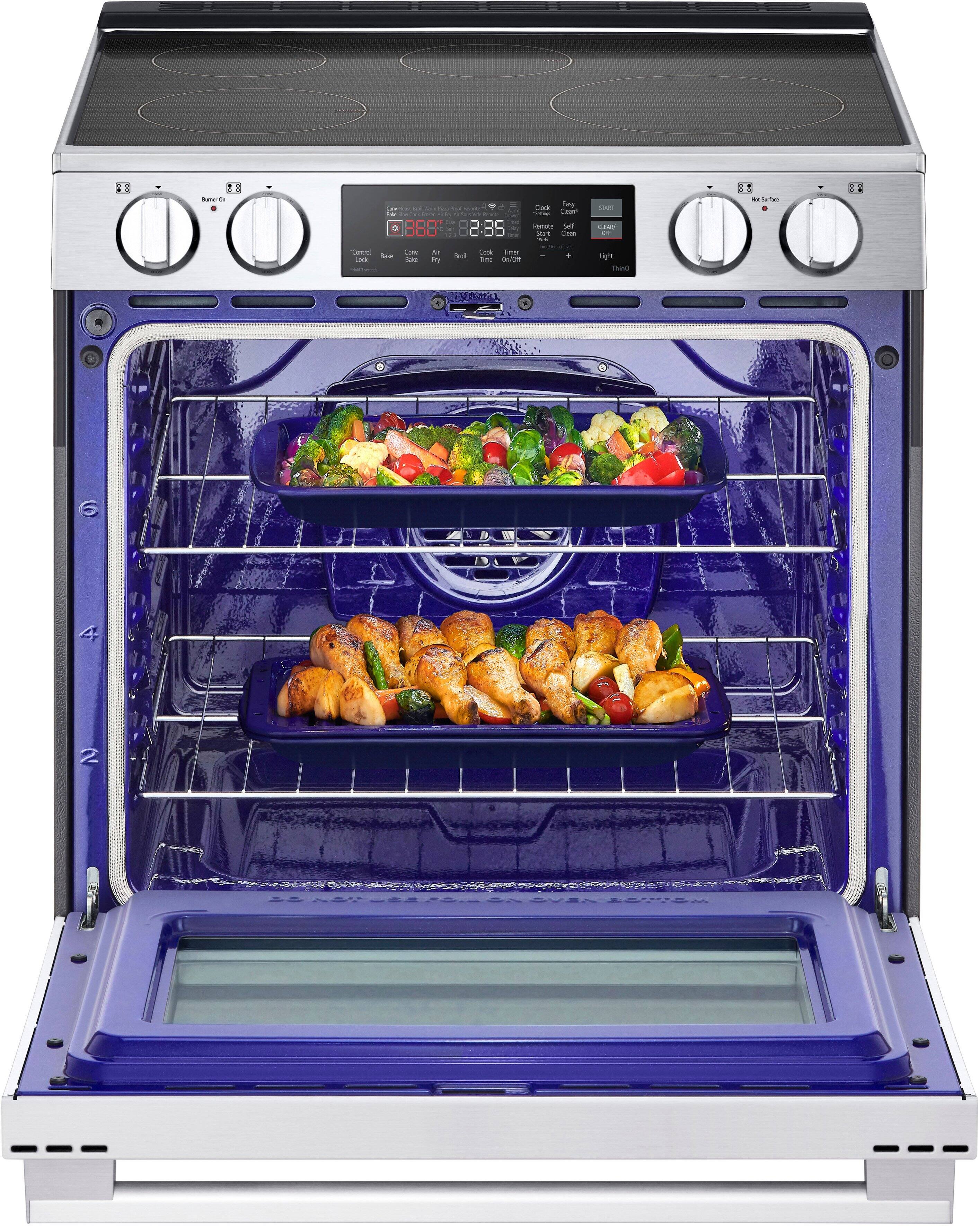 The image shows a blue oven with three different dishes cooking inside. The oven is filled with food, and the dishes are placed on different racks. The oven is equipped with a digital display, which shows the time and temperature of the cooking process. The oven is open, revealing the delicious meals being prepared.
