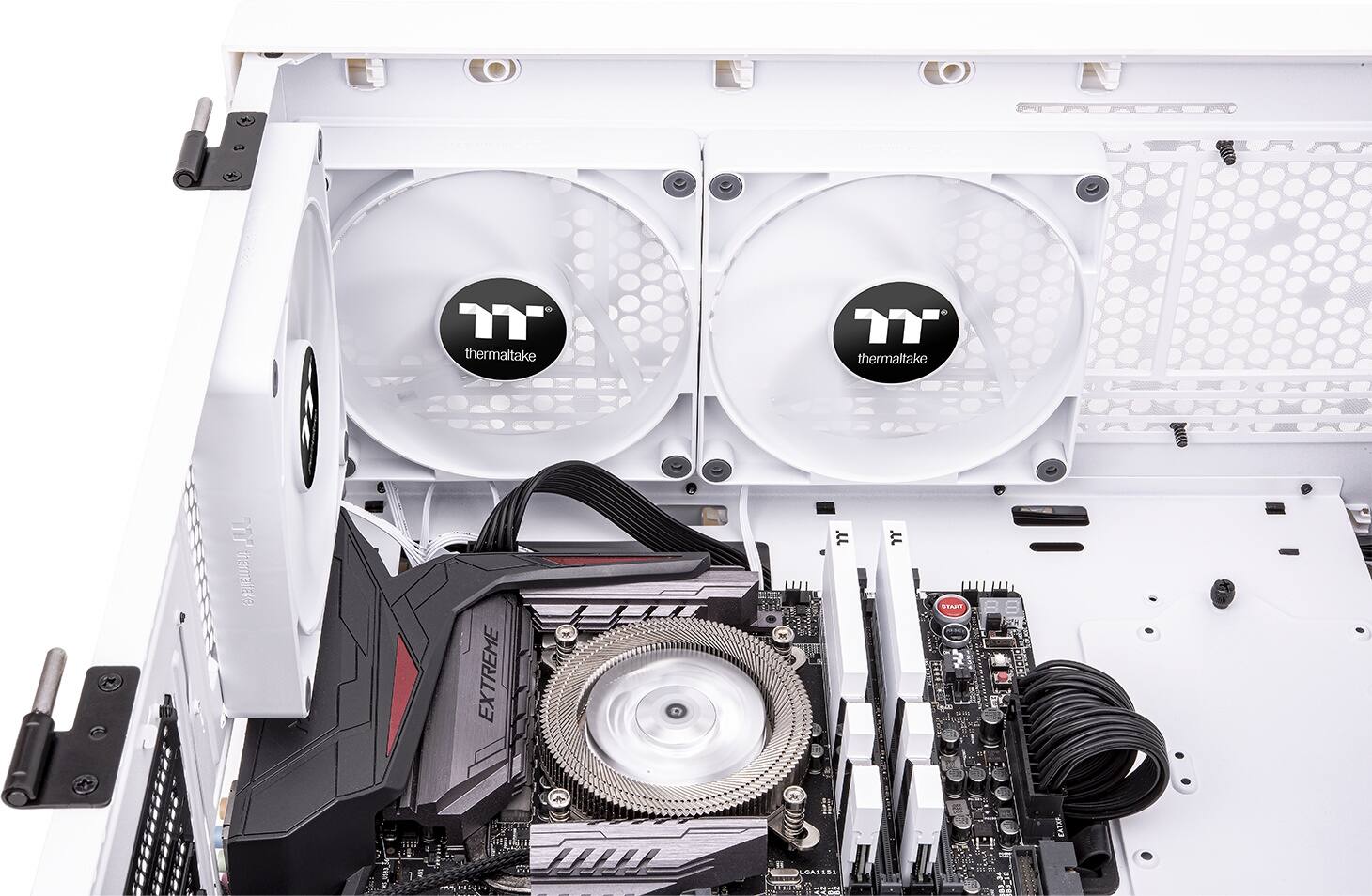 The image shows a computer with a Thermaltake brand CPU cooler and fan. The cooler is designed to keep the CPU cool and prevent overheating. The fan is located on the side of the computer, and it is likely that the computer is in a case. The presence of the Thermaltake brand suggests that the computer is built for performance and reliability.