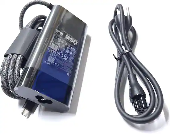 Sure, here is the corrected and grouped text from the image:
---
**USB Certified Charger**
- **Input:** 100-240V ~ 50/60Hz 0.5A
- **Output:** 19.5V 3.34A
- **Power:** 65W
- **Model:** L00M
- **Certifications:** CE, FCC, RoHS, etc.
- **Warnings and Instructions:** (Various icons and text indicating safety and usage instructions)
---
This text is based on the visible labels and markings on the charger in the image.