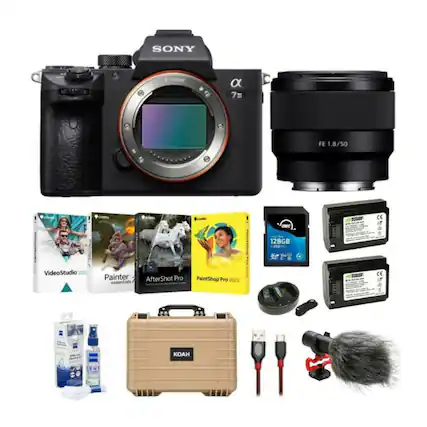 The image features a Sony camera and lens, along with various accessories and items. These include a camera case, a memory card, a battery, a strap, and a cleaning cloth. There are also books related to photography and video editing, such as Painter, VideoStudio, and AfterShot Pro. Additionally, there are two bottles, possibly containing cleaning solutions or other camera-related items. The arrangement of these items suggests that they are part of a photography or videography setup.