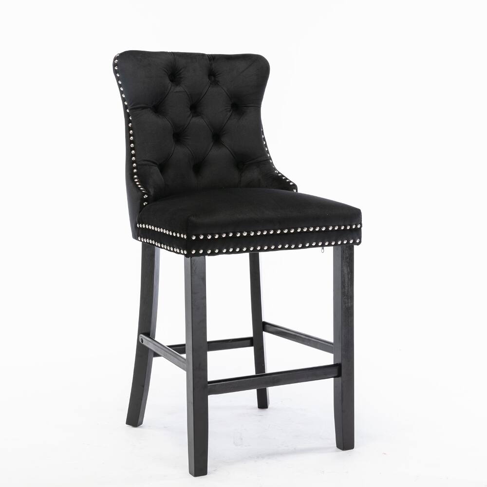 The image shows a black tufted bar stool with silver nailhead trim.