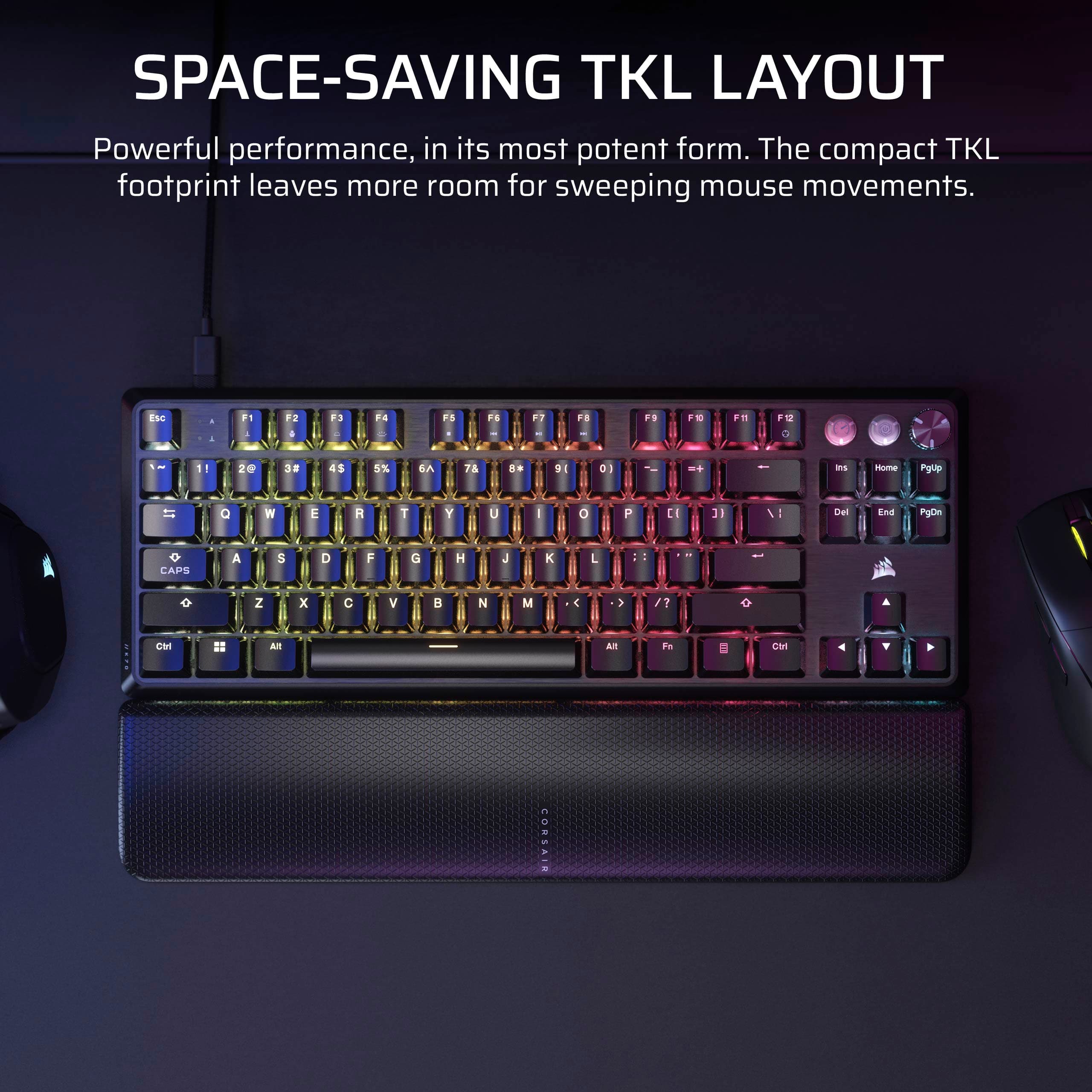 The image features a colorful keyboard with a space-saving TKL layout, which is designed to provide powerful performance in a compact form. The layout leaves more room for sweeping mouse movements, making it an ideal choice for users who want to maximize their workspace. The keyboard is placed on a black surface, and there is a mouse nearby.