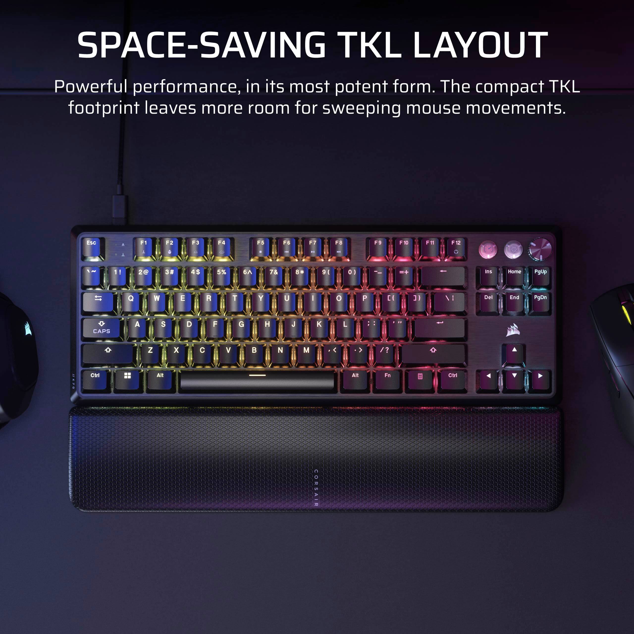 The image features a colorful keyboard with a space-saving TKL layout, which is designed to provide powerful performance in a compact form. The layout leaves more room for sweeping mouse movements, making it an ideal choice for users who want to maximize their workspace. The keyboard is placed on a black surface, and there is a mouse nearby.