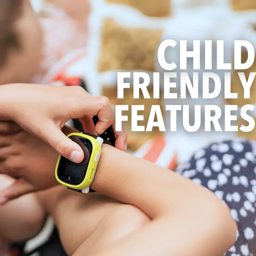 The image shows a person wearing a watch on their wrist, with the watch being held in place by a child. The watch appears to be a child-friendly device, possibly designed for children to wear and use. The child is sitting on a bed, and the scene suggests a comfortable and playful environment.
