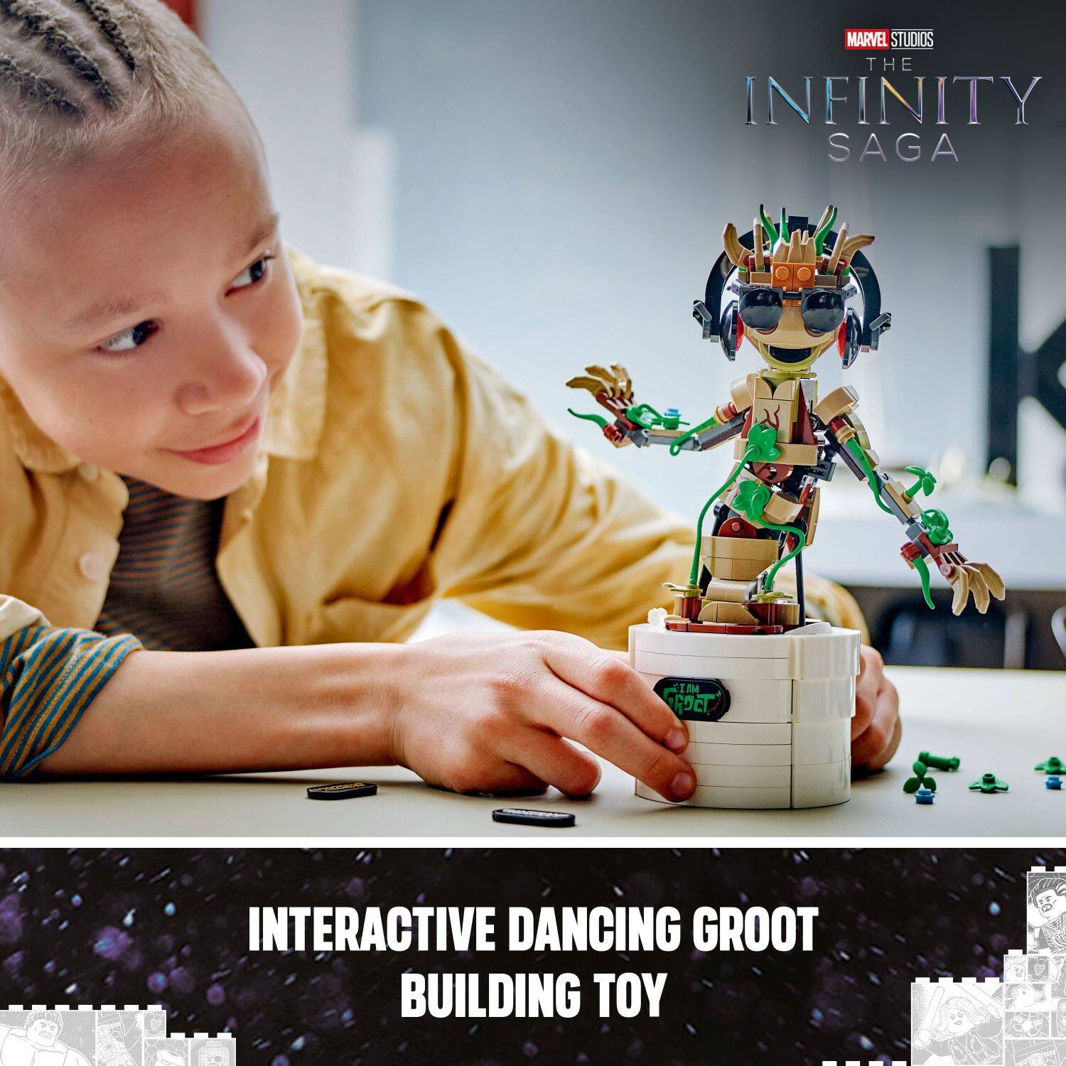 The image features a young boy holding a toy robot, which is an interactive dancing Groot from the Marvel Studios The Infinity Saga. The boy is sitting at a table, and there are several small figures on the table as well. The scene suggests that the boy is playing with the toy and enjoying the interactive dancing feature.