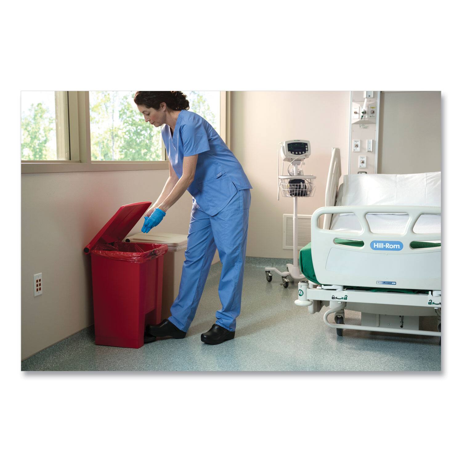 Angle. RubberMaid - Indoor Utility Step-On Waste Container, 18 gal, Plastic, Red.
