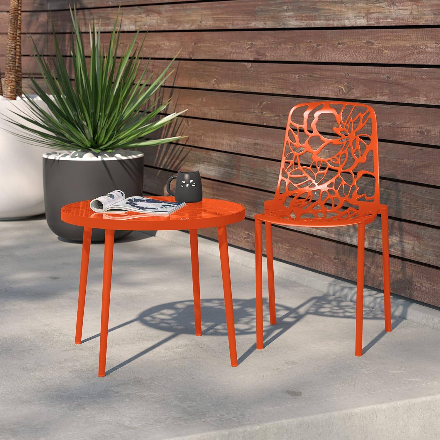 Angle. LeisureMod - Devon Stackable Aluminum Dining Chair, Modern Floral Cutout Indoor/Outdoor Patio Chair - Fully Assembled - Orange.
