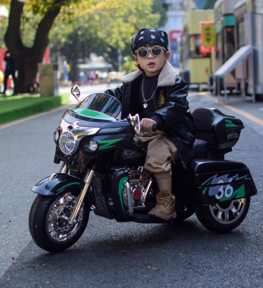 Angle. BreeBe - 12V Kids Electric Motorcycle, Two-Seat Ride On with Key Start, 3 Wheels, Headlight, Storage Box, Dual Motors - Black.