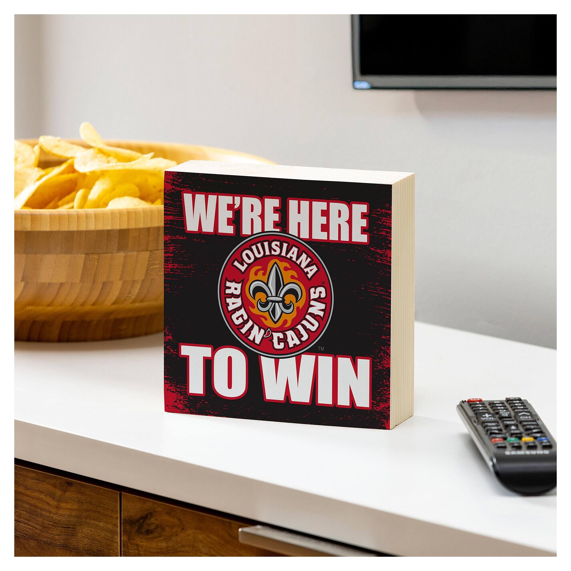 WE'RE HERE  
LOUISIANA RAGIN CAJUNS  
TO WIN