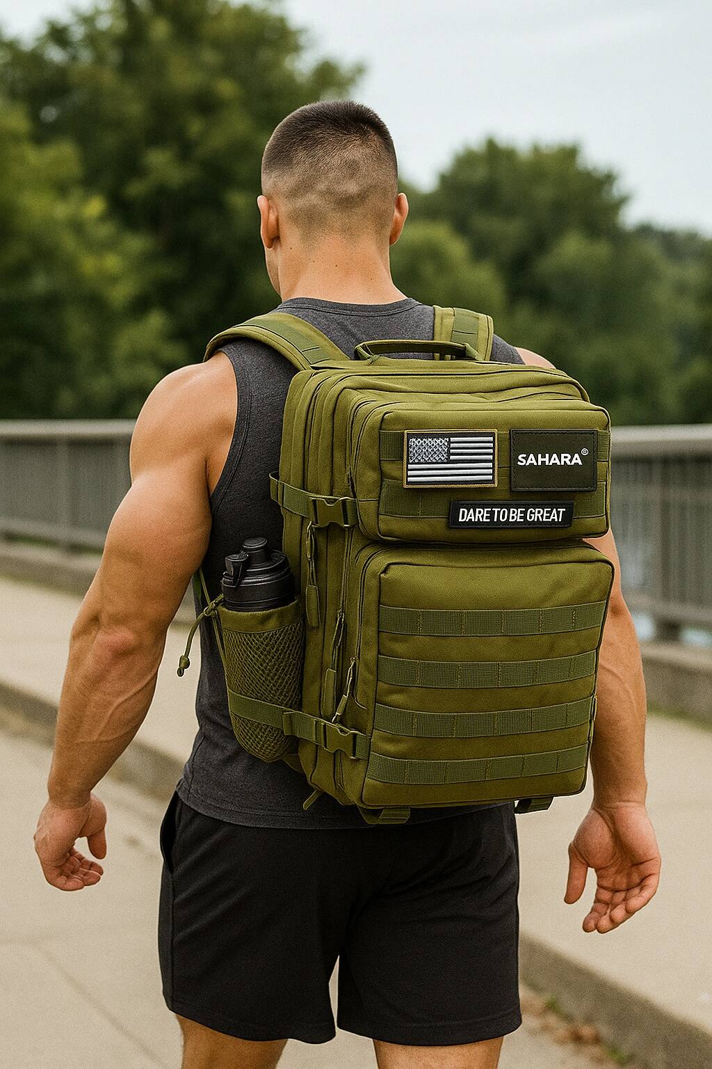 The man in the image is wearing a backpack that says "Sahara" and "Dare to be great."