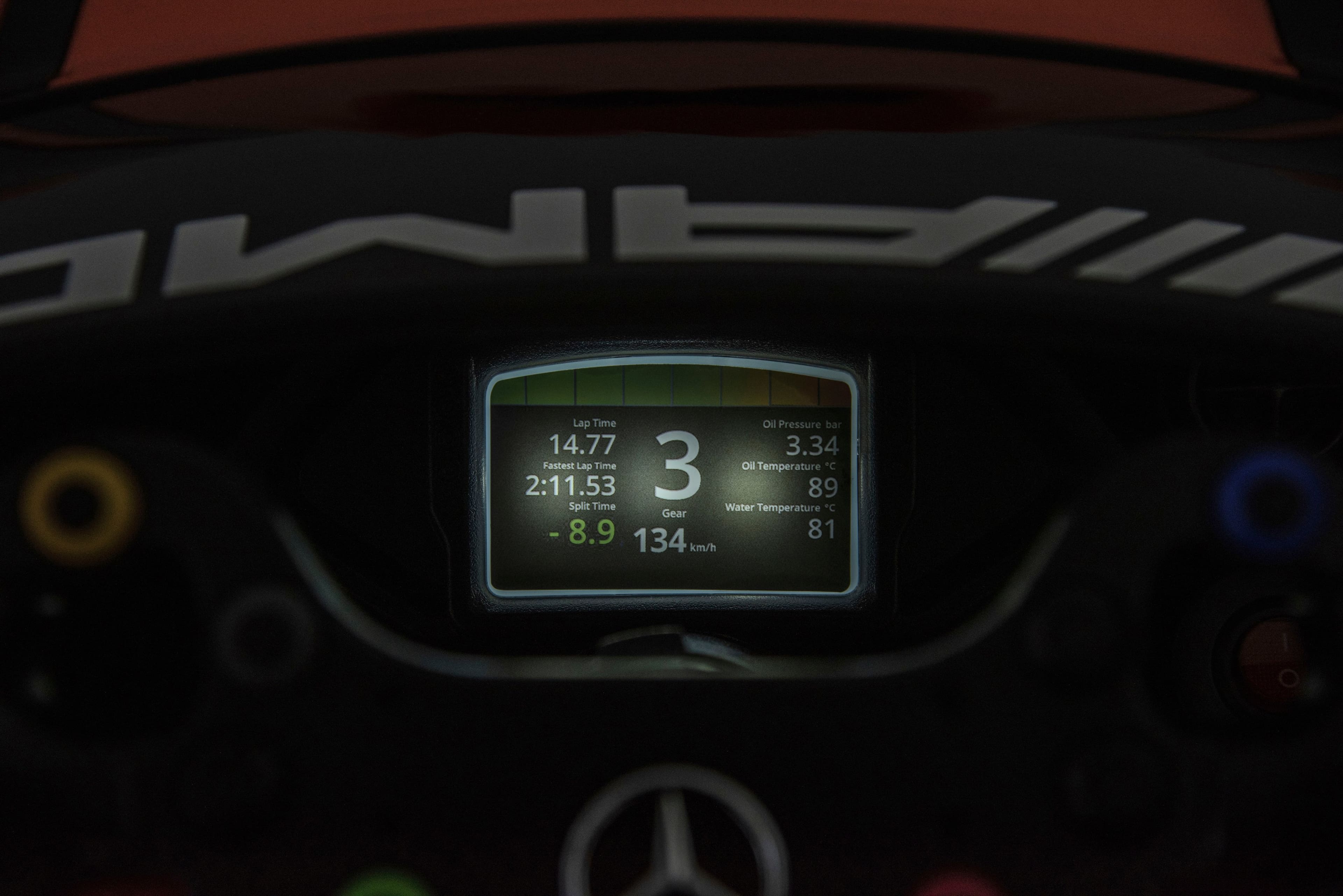 The text on the image reads:
Lap Time: 2:11.53
Oil Temperature: C
Water Temperature: C
Gear: -
Oil Pressure: 8.9 bar
Oil Temperature: 89°C
Split Time: 14.77
The corrected text would be:
Lap Time: 2:11.53
Oil Temperature: C
Water Temperature: C
Gear: -
Oil Pressure: 8.9 bar
Oil Temperature: 89°C
Split Time: 14.77