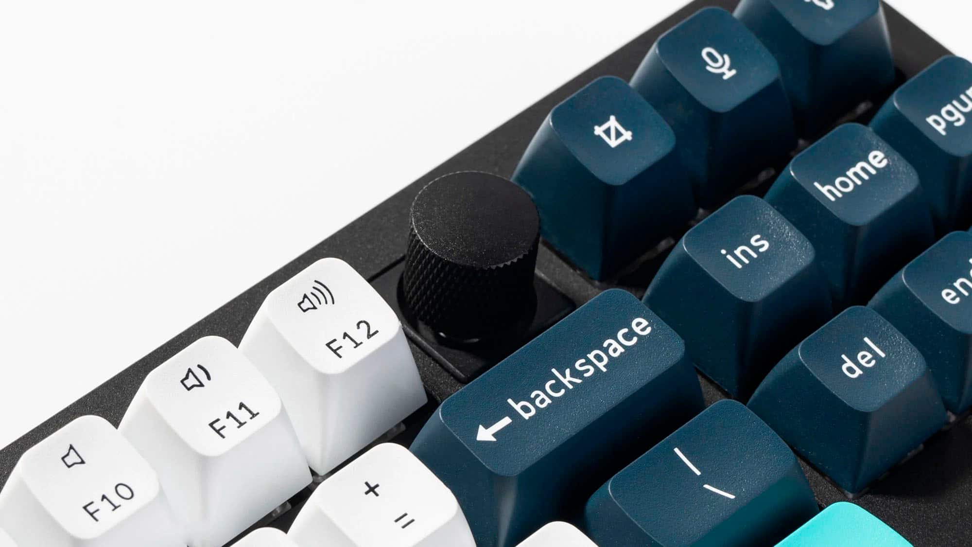 The image shows a close-up of a keyboard with a mix of blue and white keys. The keys are arranged in a way that they are not grouped together, but rather scattered across the keyboard. The text on the image does not provide a clear grouping of the keys.