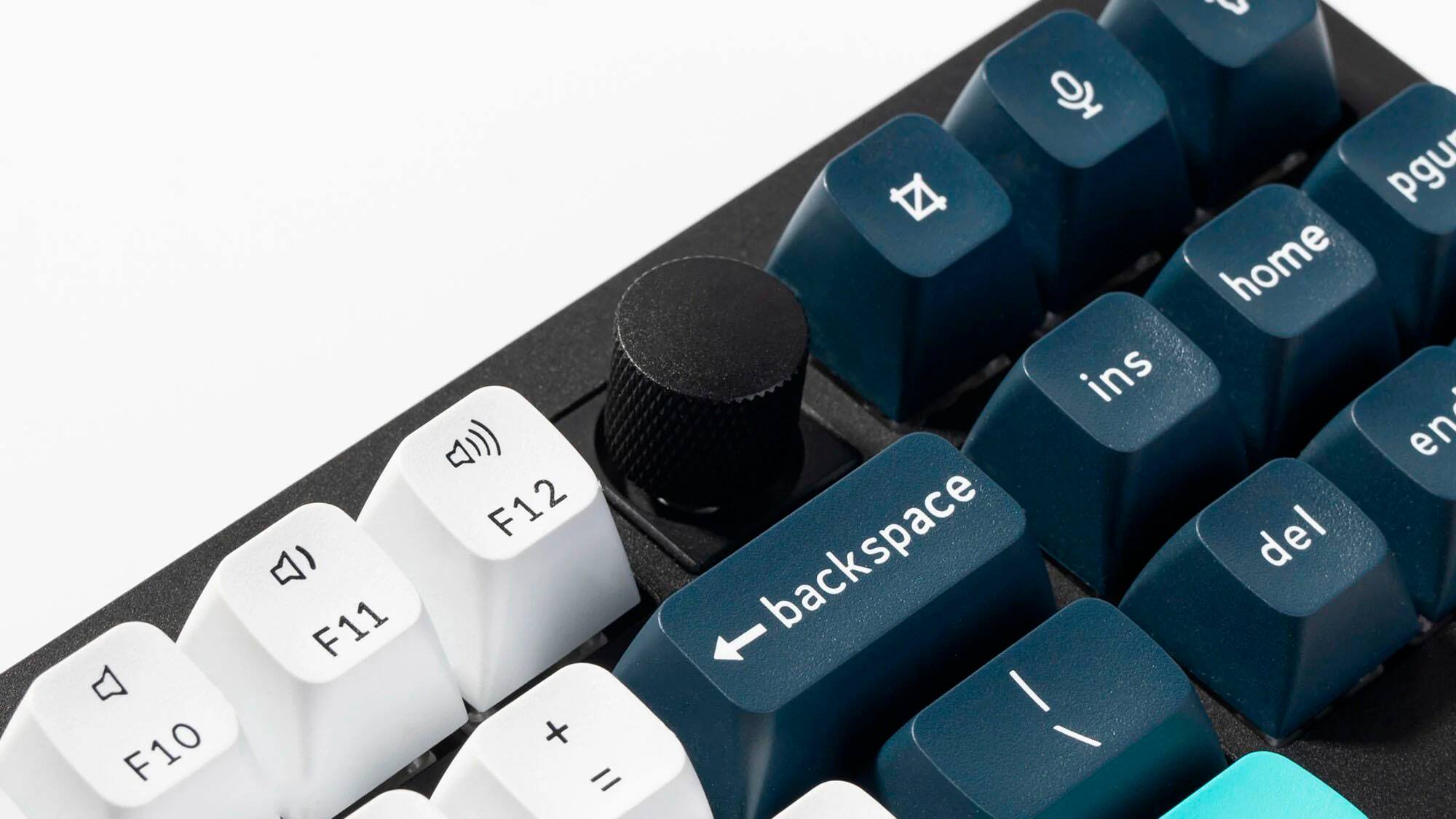 The image shows a close-up of a keyboard with a mix of blue and white keys. The keys are arranged in a way that they are not grouped together, but rather scattered across the keyboard. The text on the image does not provide a clear grouping of the keys.