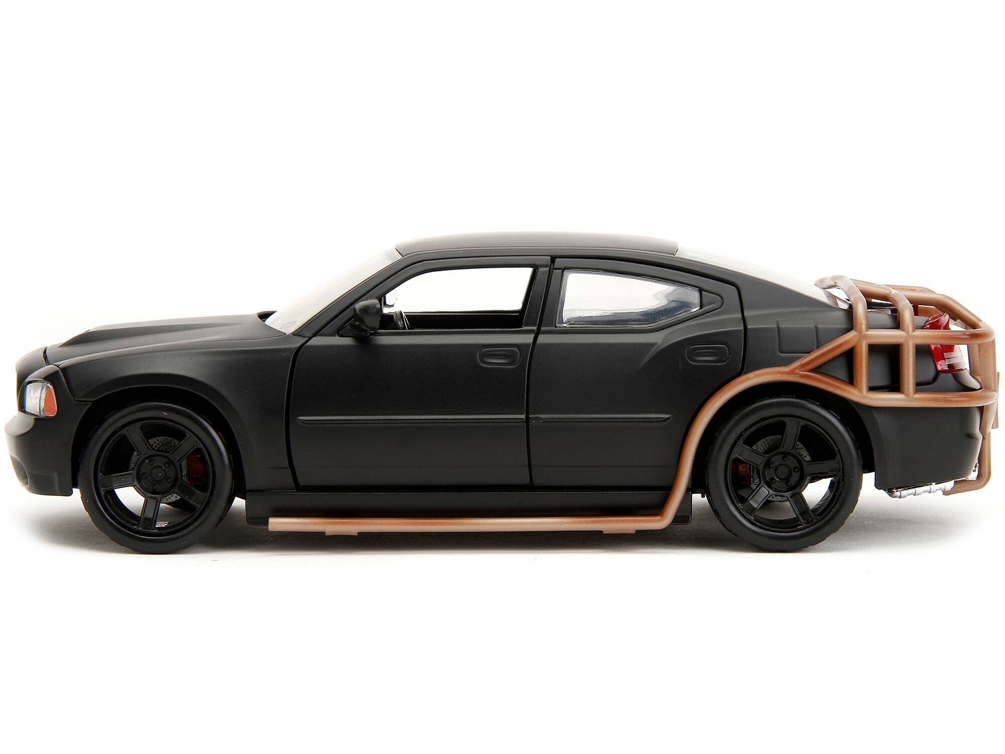 Left. Jada - 2006 Dodge Charger Matt Black with Outer Cage "Fast & Furious" Movie 1/24 Diecast Model Car by Jada - Matt Black.