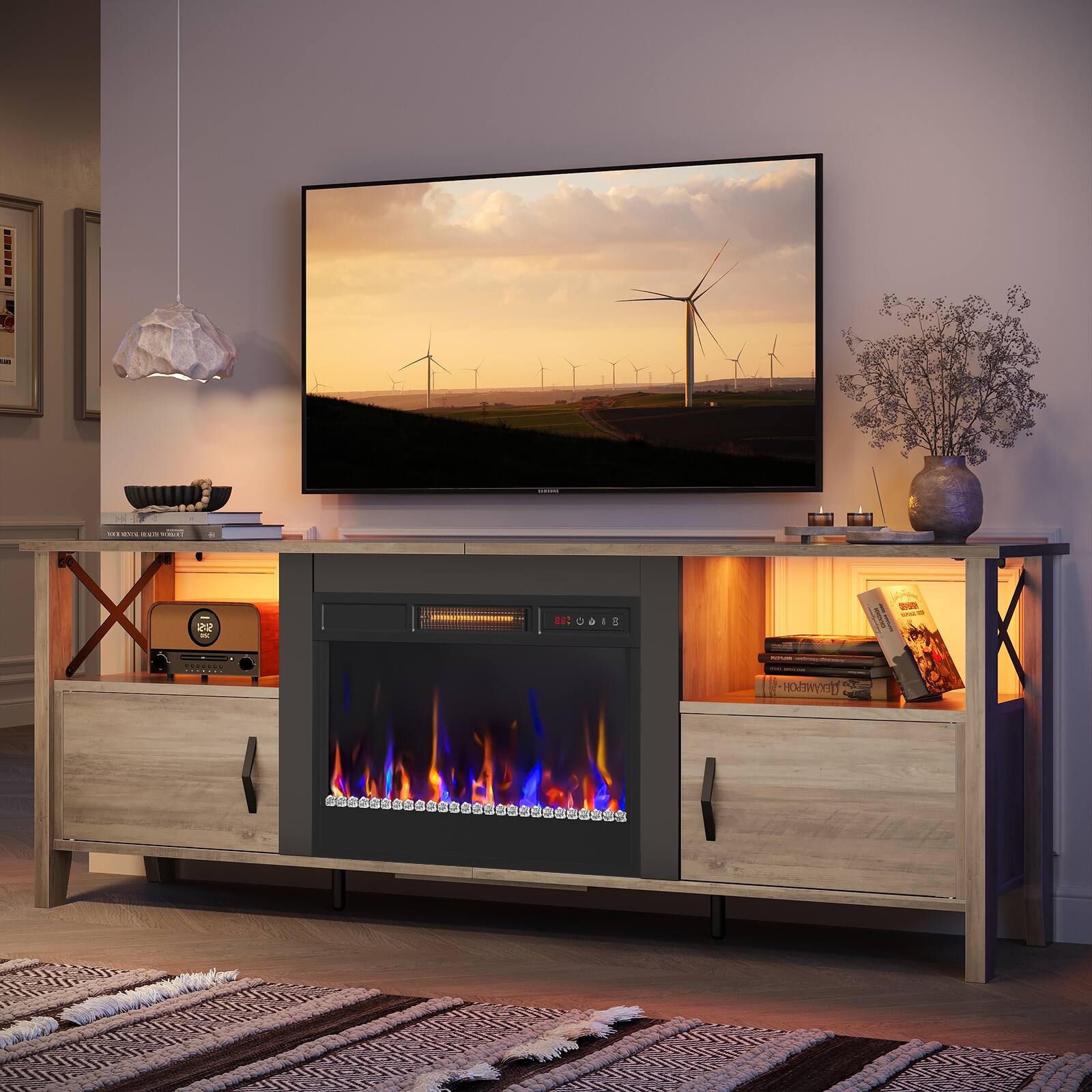 The image features a living room with a flat screen TV mounted on the wall. The TV is turned on and displaying a scene of windmills. The room also has a fireplace, which adds to the cozy atmosphere. There are several books scattered around the room, and a vase is placed nearby. Additionally, there is a clock on the wall, and a remote control can be seen close to the TV. The room is well-decorated and inviting, making it an ideal space for relaxation and entertainment.