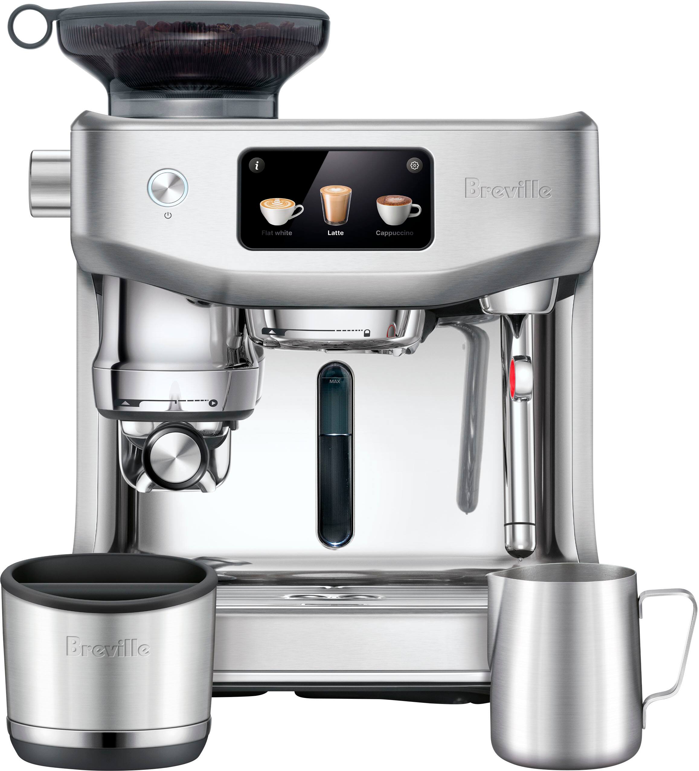 The image features a silver coffee maker with a digital display, which is a Breville Piat white Latte Cappuccino machine. The coffee maker is sitting on a counter, and it is accompanied by a cup and a spoon. The coffee maker is designed to make coffee, cappuccino, and latte, offering a variety of options for users to enjoy their beverages.