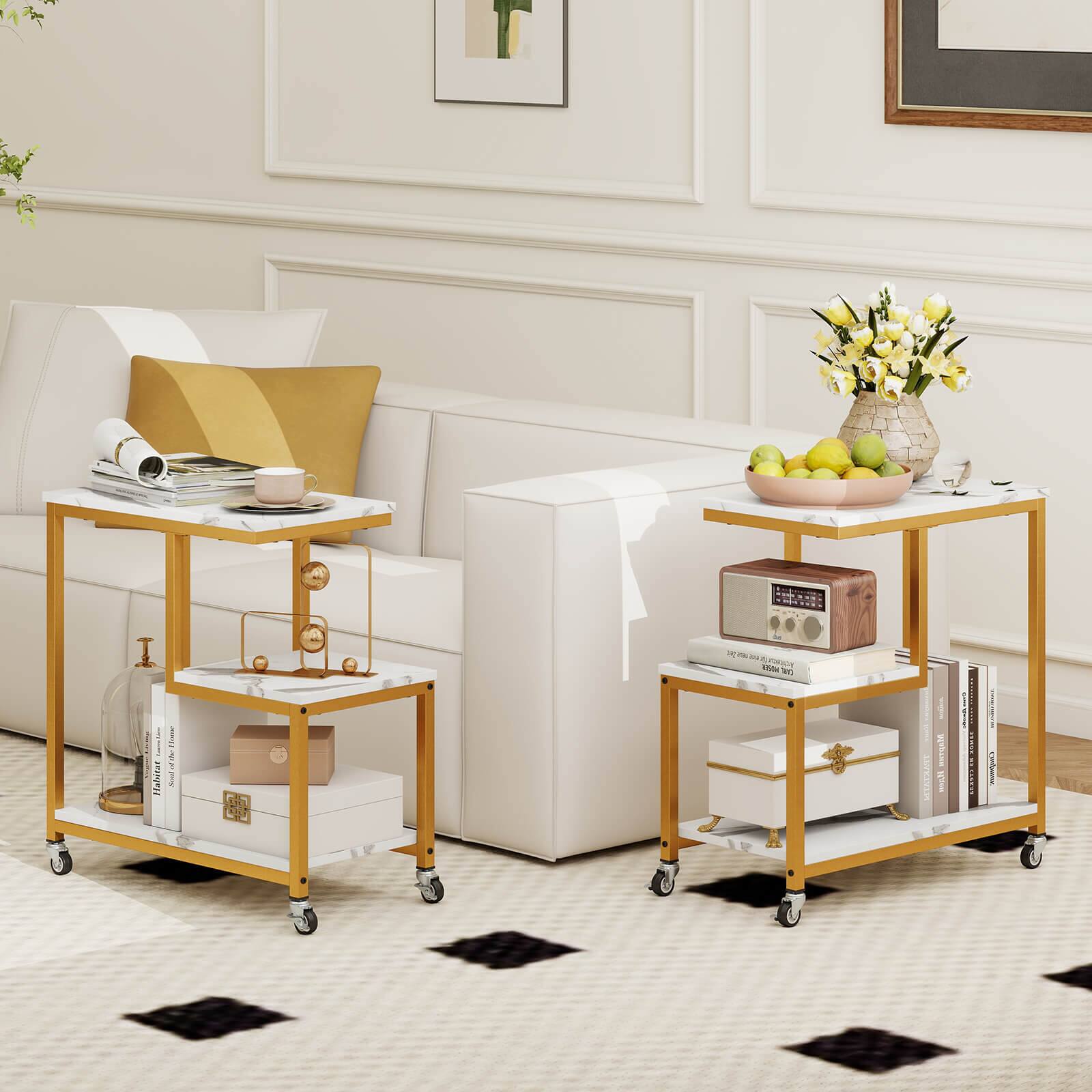 The image shows a living room with a white couch and two tables. One table has a vase of flowers on it, while the other has a radio and a bowl of fruit. There are also books on the tables, and a couple of apples are visible on the table with the radio. The room is decorated with a potted plant and a vase, creating a cozy and inviting atmosphere.