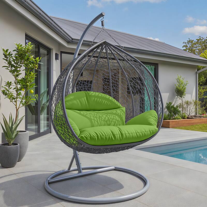 Angle. LeisureMod - Recluse Grey Wicker Hanging Egg Chair - Modern Indoor Outdoor Swing with Stand, 440lb Capacity - Light Green.