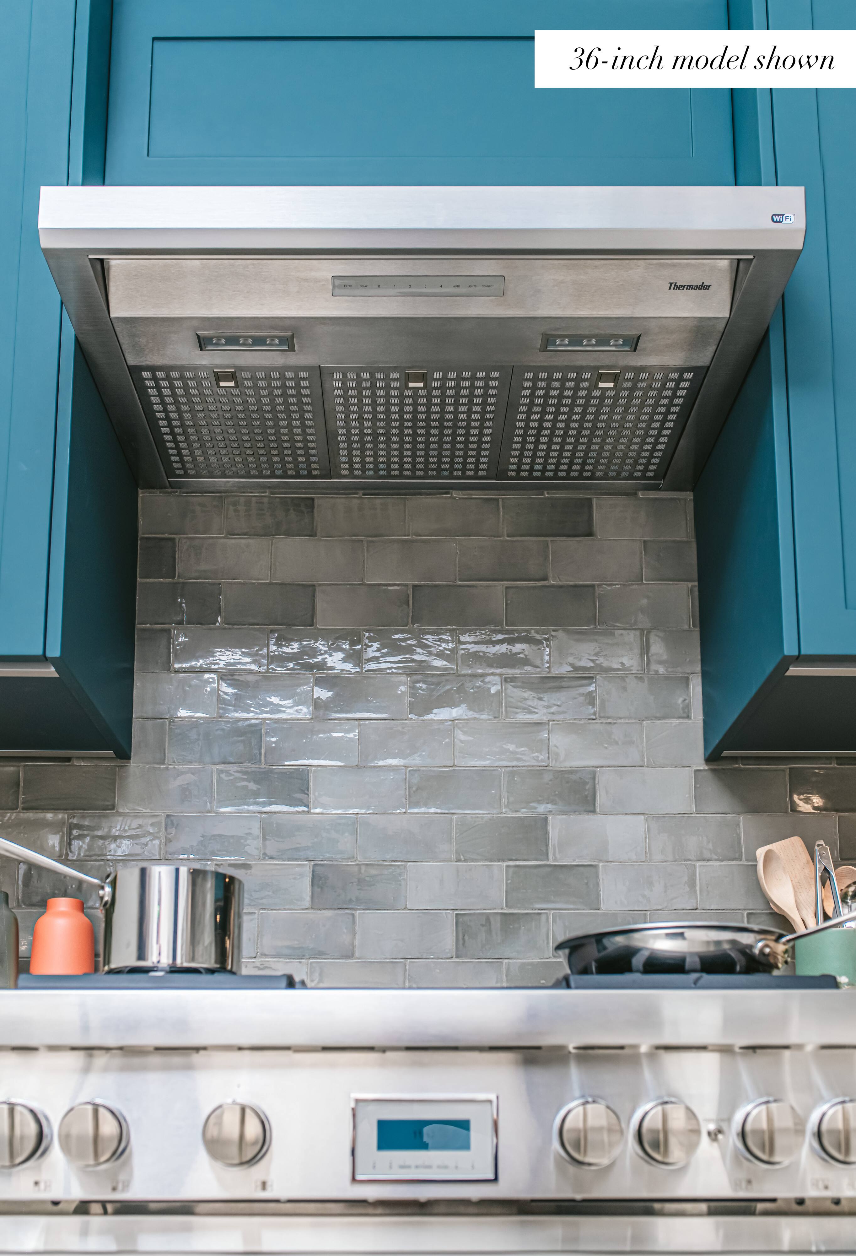 The text on the image reads "36-inch model shown W F Thermador SIJ FA . L Rd L LA LA." This text is likely meant to provide information about the size of the oven and its brand. The oven is a 36-inch model, and it is made by Thermador.