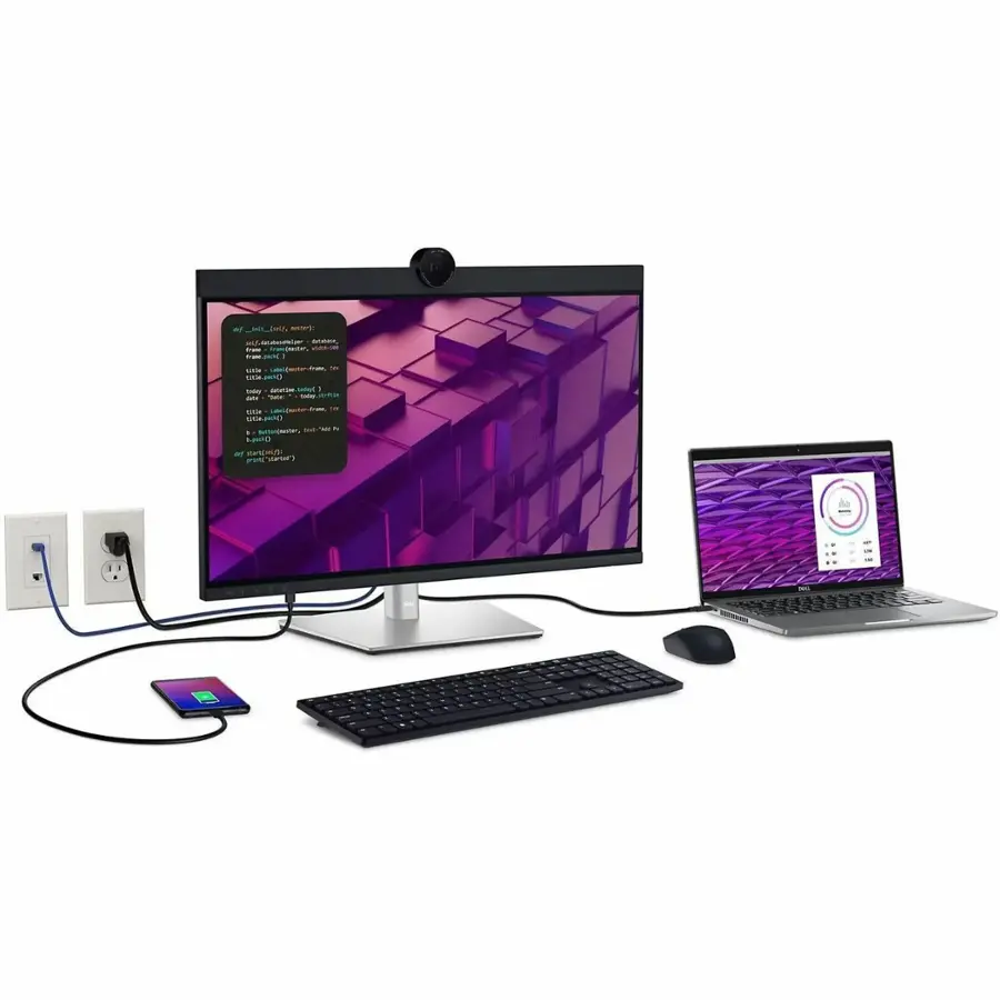 The image features a computer setup with a laptop and a monitor. The laptop is positioned to the right of the monitor, and a keyboard is placed in front of the monitor. Additionally, there is a cell phone on the left side of the monitor. The setup appears to be a workstation for productivity and multitasking.