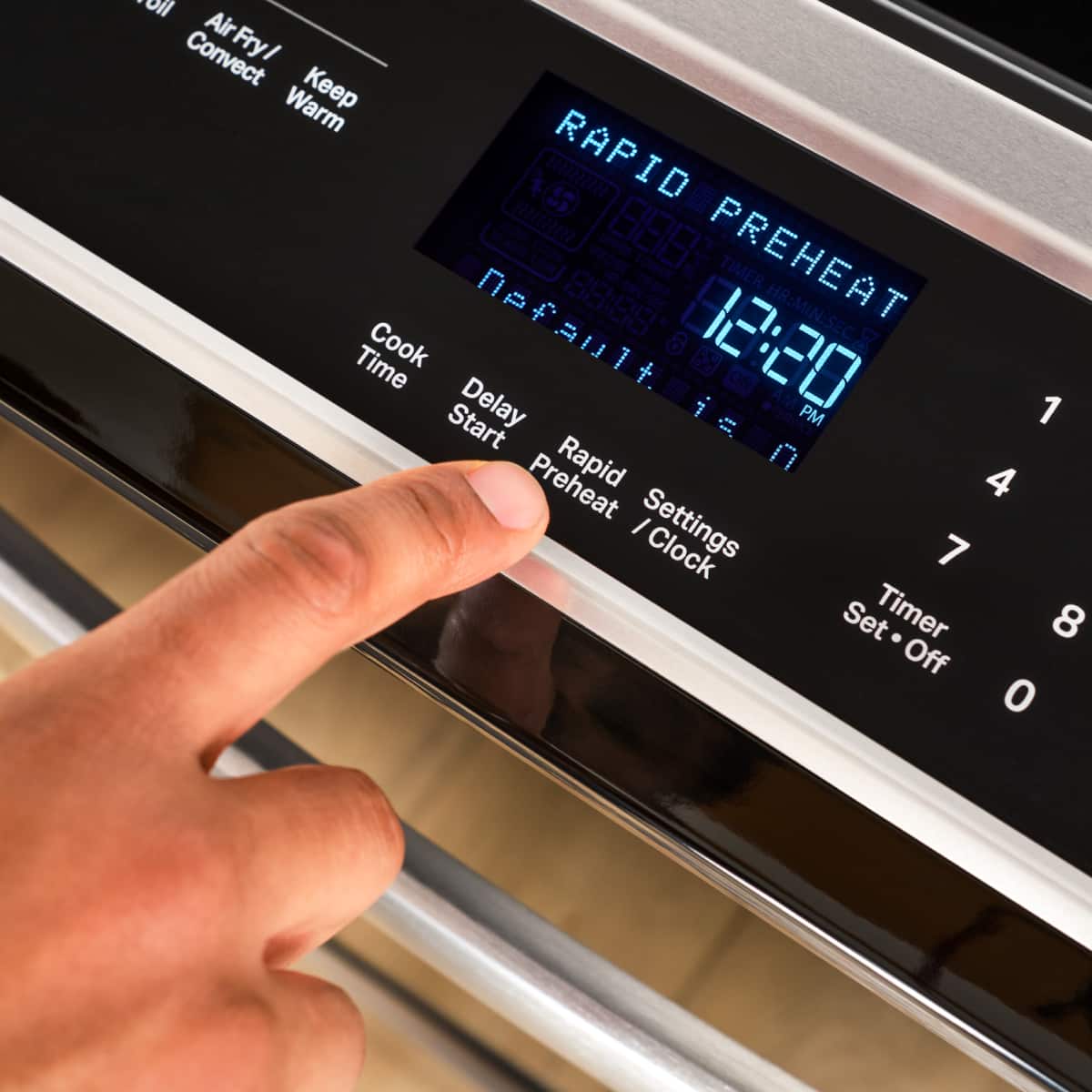 Sure, here is the corrected and grouped text from the image:
- **Top Left:**
- Oil
- Air Fry/ Convect
- Keep Warm
- **Top Right:**
- RAPID PREHEAT
- 12:20 PM
- **Bottom Left:**
- Cook Time
- Delay Start
- Rapid Preheat
- Settings / Clock
- **Bottom Right:**
- Timer Set / Off
- **Buttons:**
- 1
- 2
- 3
- 4
- 5
- 6
- 7
- 8
- 0