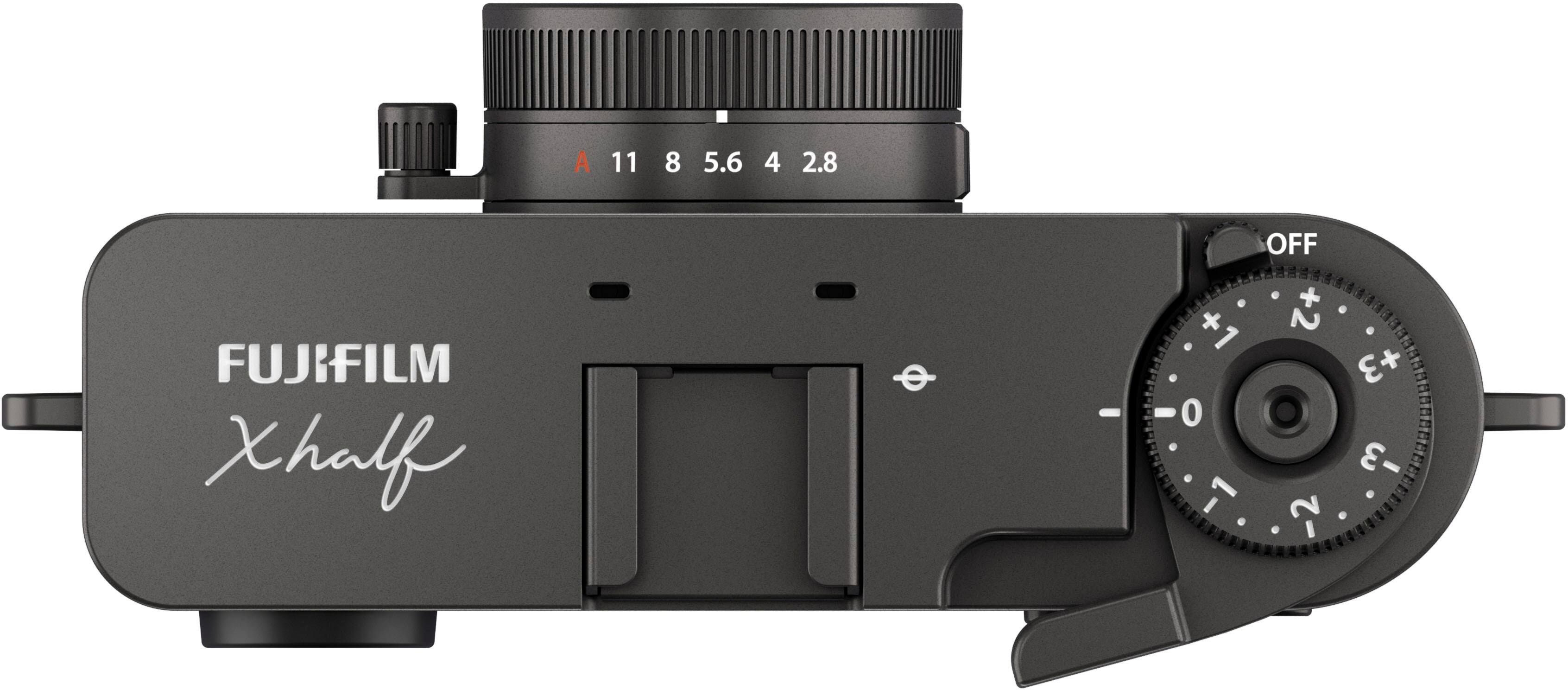 A FUJIFILM xHalf camera with a lens on it. The camera has a dial with the numbers 1, 2, 3, 4, 5, 6, 7, 8, 9, 10, and 11. The dial also has a "+" and "-" sign, as well as an "OFF" button.