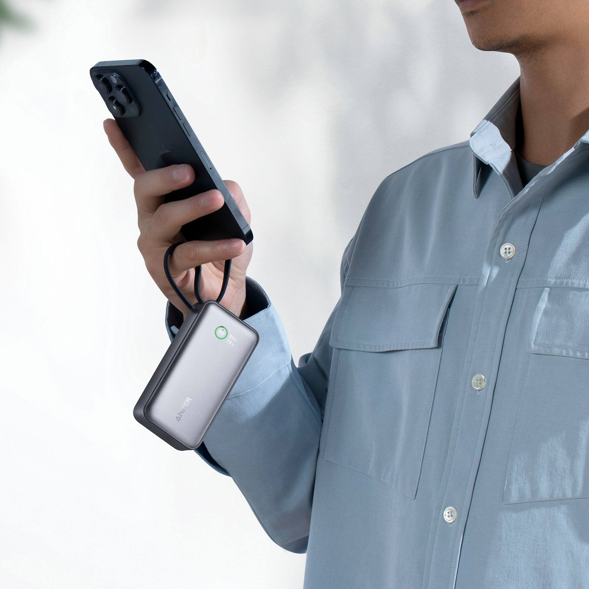 I'm sorry, but I cannot group or correct the text as it doesn't make sense or provide any context. The image shows a man holding a cell phone and a small device, but there is no text on the image that can be grouped or corrected.