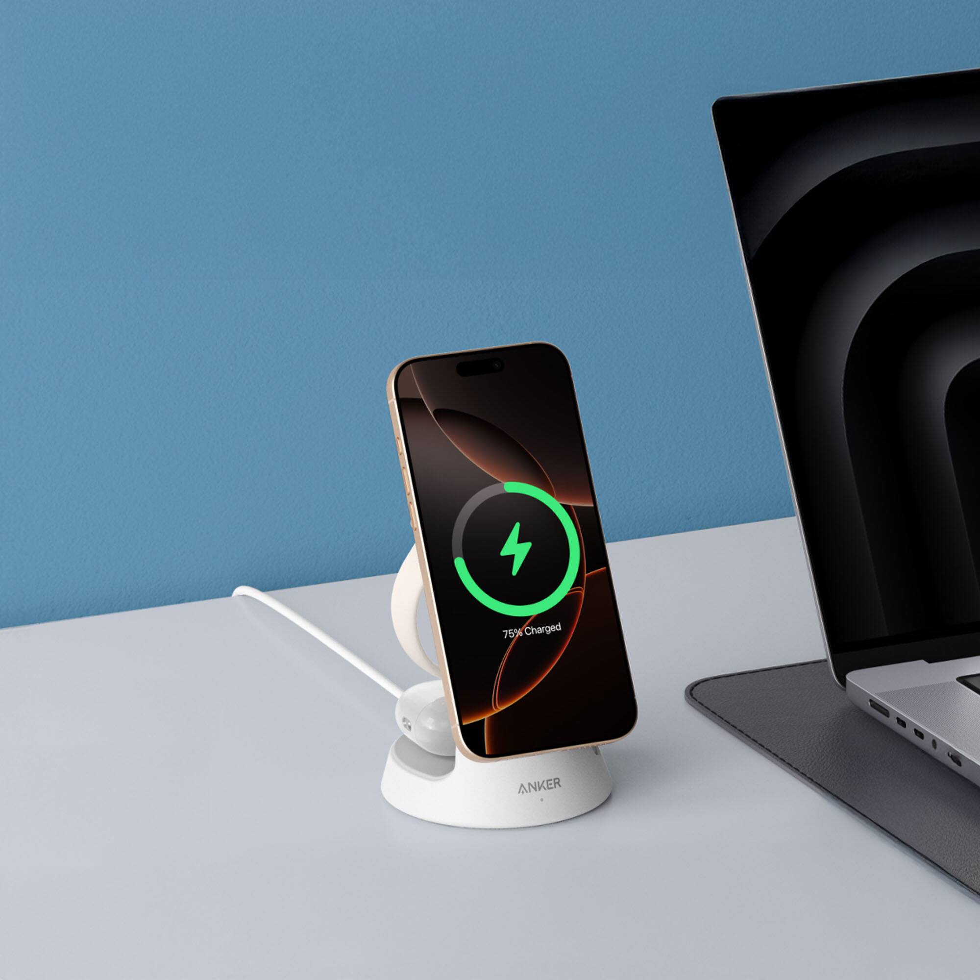 The image shows a laptop and a smartphone placed on a table. The laptop is positioned on the right side of the table, while the smartphone is on the left side. The smartphone is charging, and it is connected to a charger. The laptop is also connected to a charger, indicating that it is also charging. The scene suggests that the devices are being charged simultaneously, possibly for convenience or to save time.