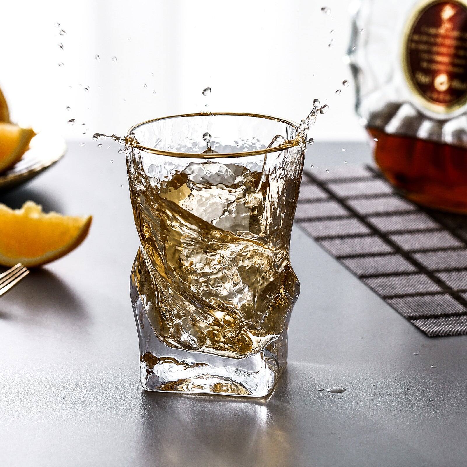 Left. BreeBe - Gold Rimmed Hammer Twist Whiskey Glass (set of 4) - 3.14"W x 4.44" H - Clear with gold rim.