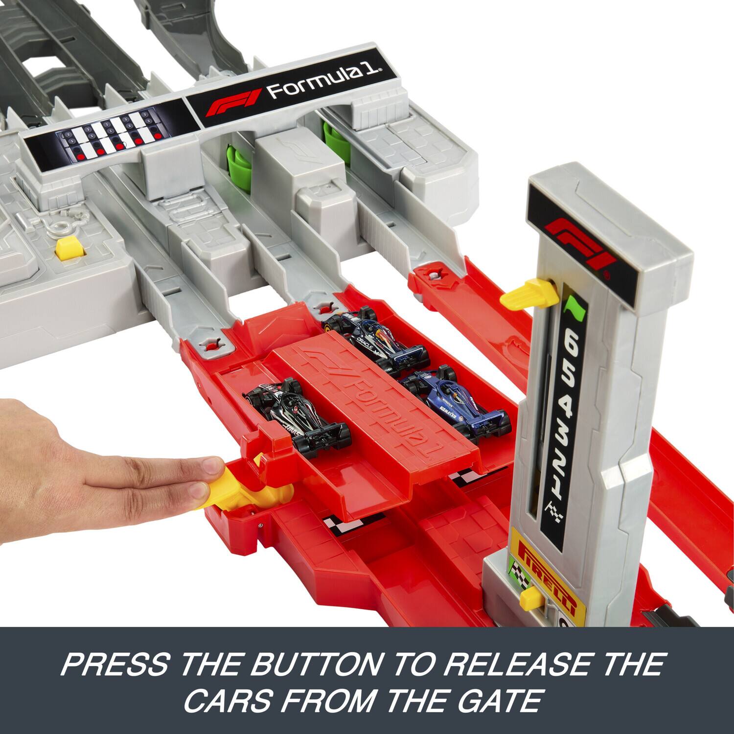 PRESS THE BUTTON TO RELEASE THE CARS FROM THE GATE