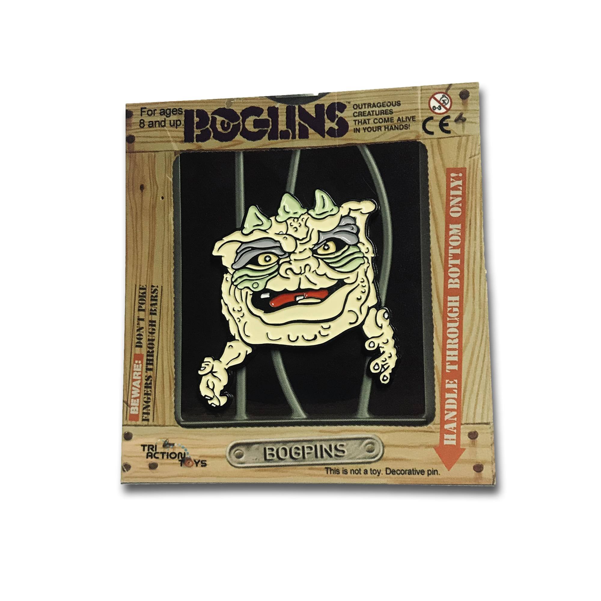 OUTRAGEOUS CREATURES THAT COME ALIVE IN YOUR HANDS!  
For ages 8 and up  

BOGINS  

BEWARE: FINGERS DON'T FIT THROUGH BOTTOM POKE BARS!  
HANDLE THROUGH BOTTOM ONLY!  

This is not a toy. Decorative pin.  

TRI ACTION TOYS