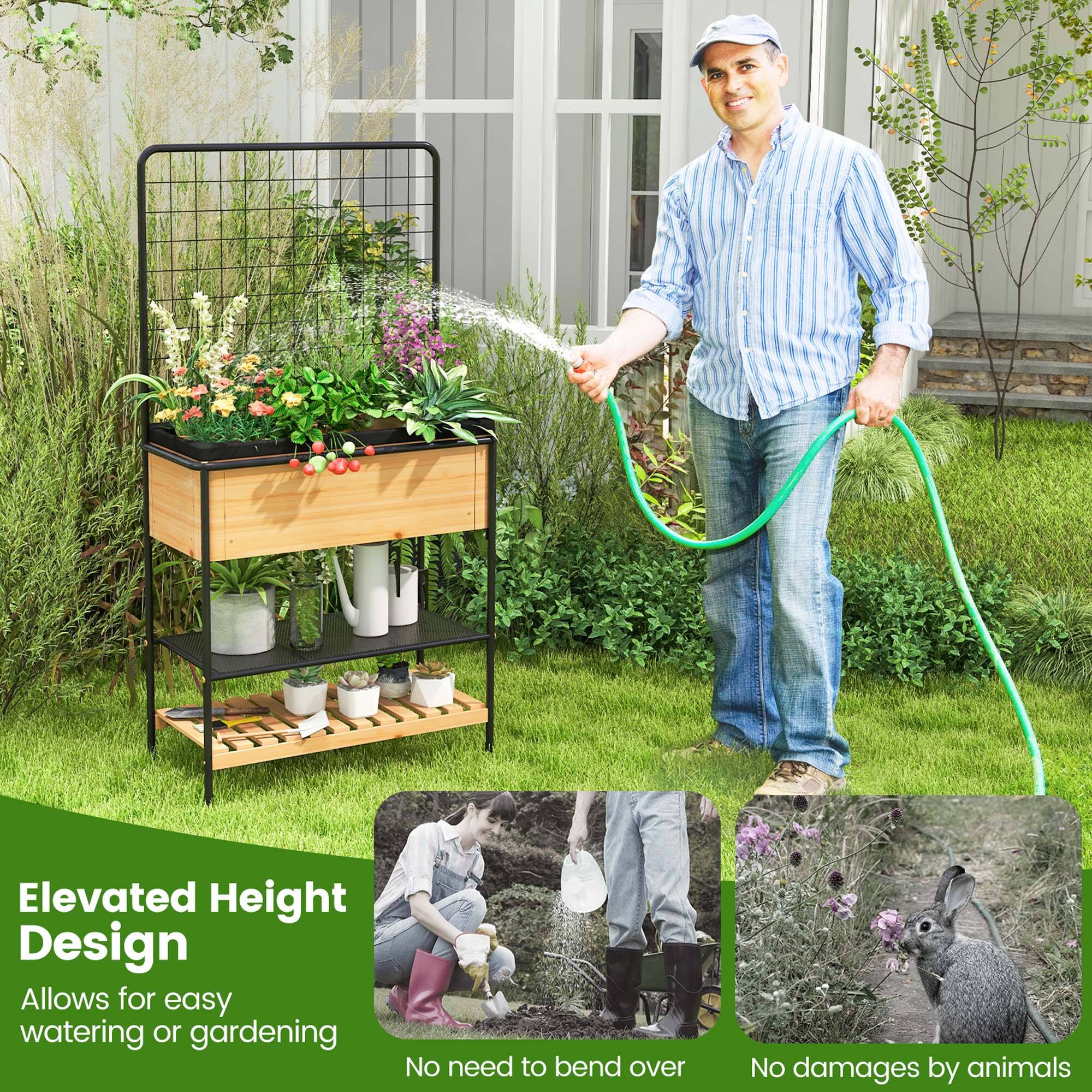 The image features a man watering plants with a hose, standing next to a wooden planter box filled with flowers. The box is elevated, allowing the man to water the plants without bending over. This design also prevents any potential damage to the plants by animals.