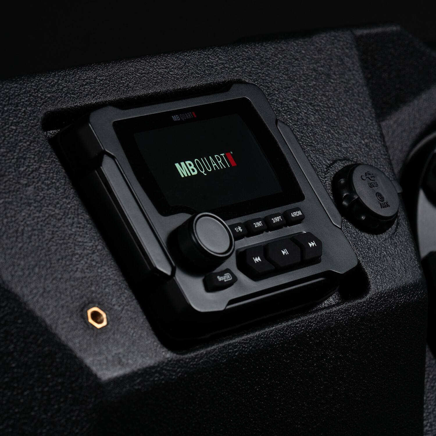 MB Quart is a company that specializes in producing high-quality audio equipment, including car stereos. The image shows a close-up of a car stereo with the MB Quart logo displayed on the screen. The stereo is mounted in a vehicle, and it is designed to provide clear and powerful sound for the driver and passengers. The MB Quart brand is known for its durability, reliability, and performance, making it a popular choice for car audio systems.