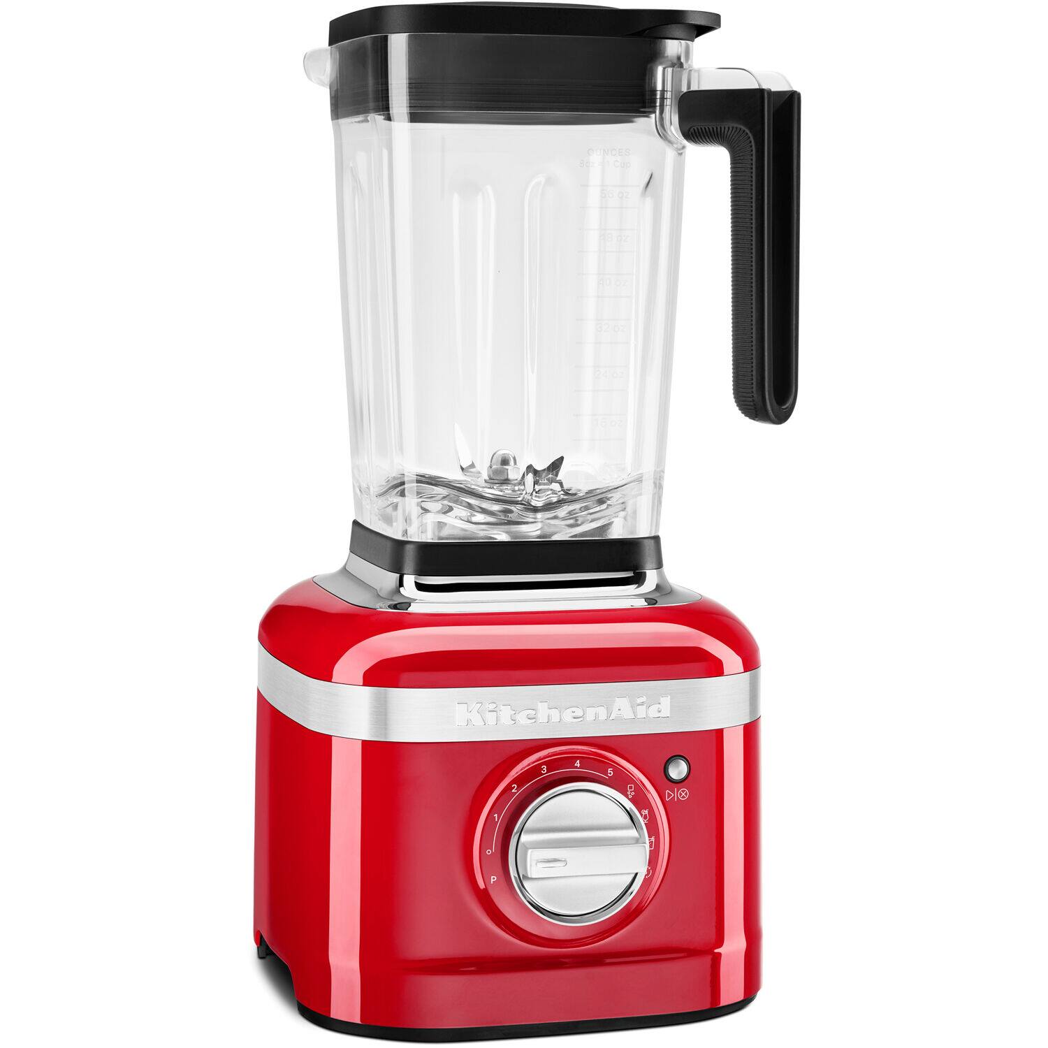 The image features a red KitchenAid blender with a black lid. The blender is filled with water and ice, and it is sitting on a counter. The blender is designed for easy use and efficient blending of ingredients.