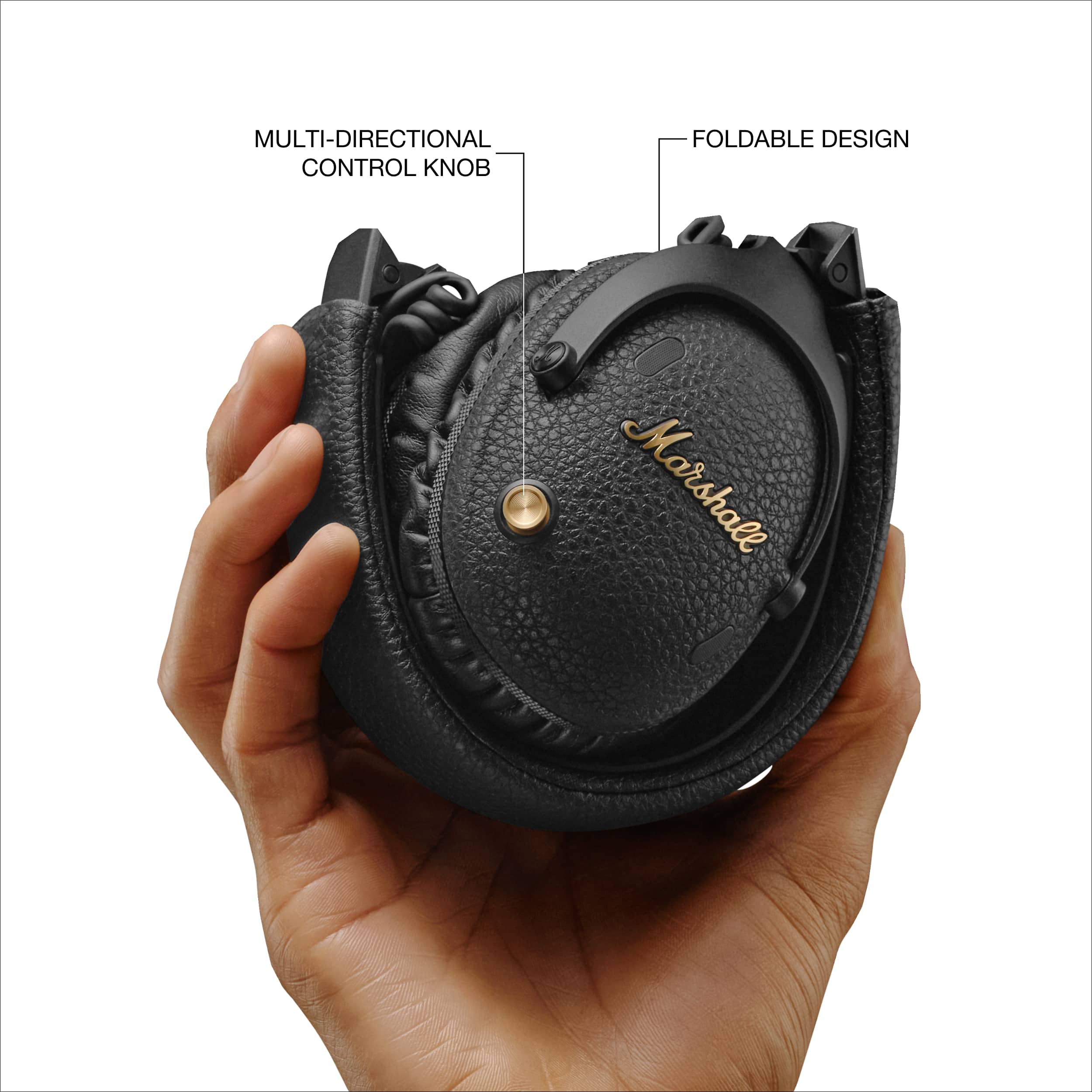 The image shows a person holding a black object, which is a Marshall headphone. The headphone has a multi-directional control knob and a foldable design, making it convenient for users to carry and use.