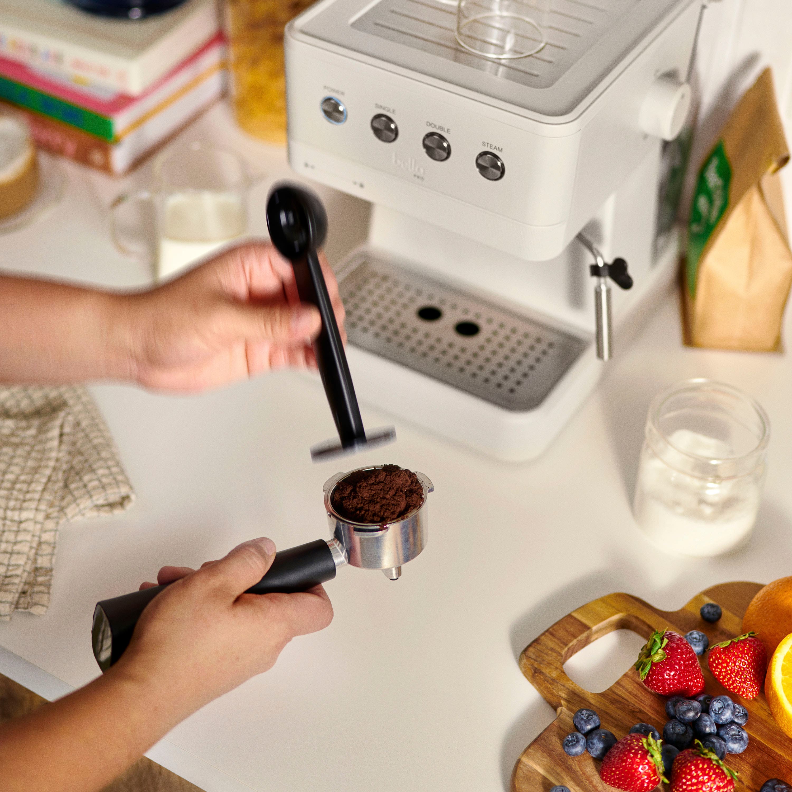 The text on the image reads "double bla steam." This is likely a reference to a coffee maker or espresso machine, which uses steam to heat water for brewing coffee or making espresso. The image shows a person preparing a cup of coffee or espresso, and there are various items on the counter, such as a cup, a bowl, and a spoon.