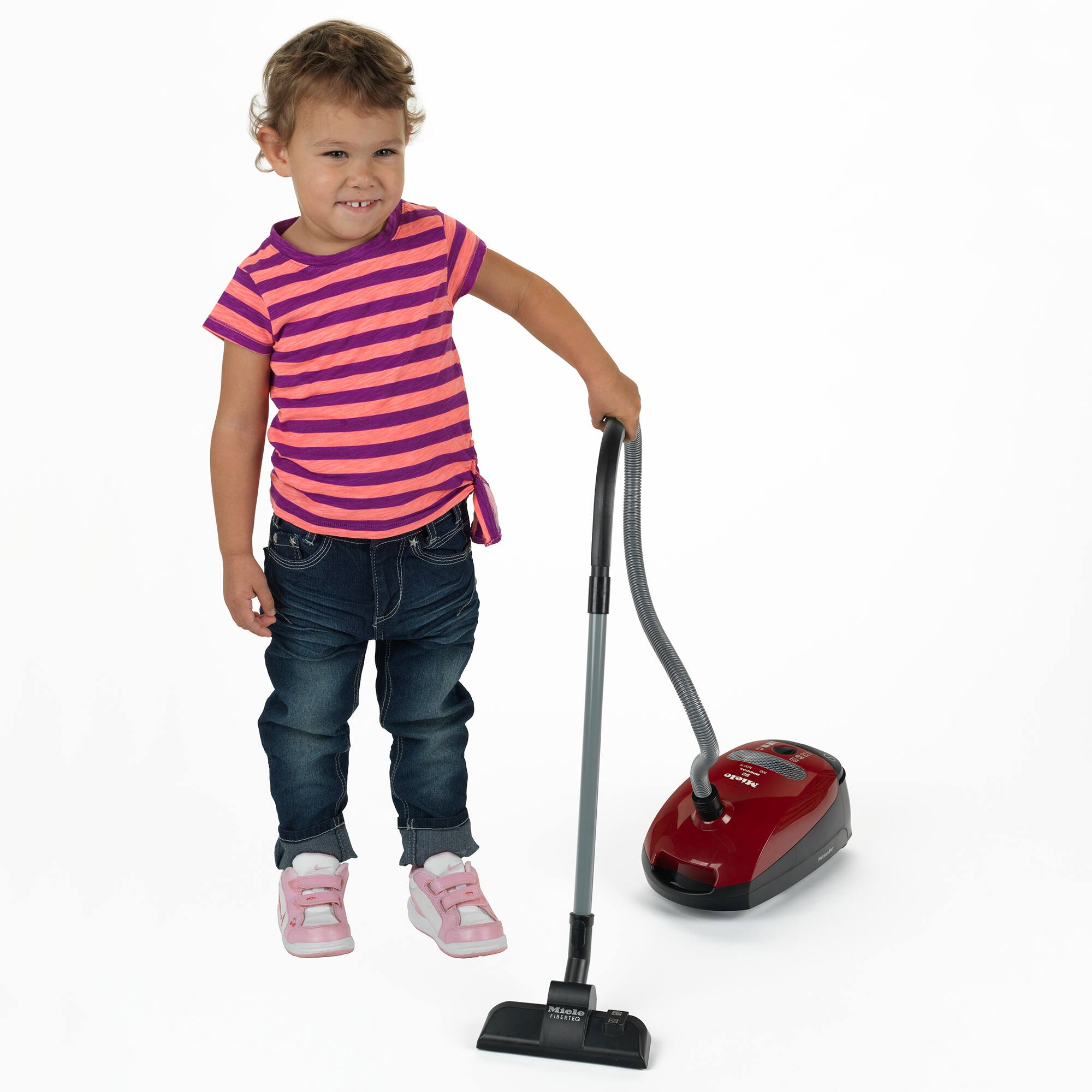 I'm sorry, but I cannot group or correct the text as it doesn't make sense or provide any context. The image shows a young girl holding a vacuum cleaner, and the text on the image is unrelated to the content of the image.