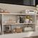 The text on the image can be grouped and corrected as follows:
1. The princess saves herself - Brianna Wiest
2. Jo Malone
3. 1000 Knots
4. Textile Designer
These sentences are related to the shelf and its contents, providing context and information about the items displayed.