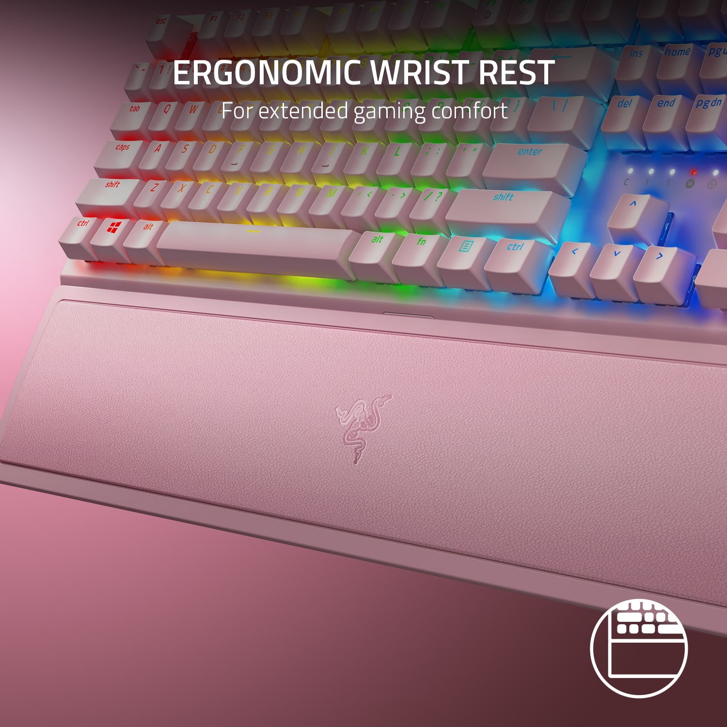 The image features a close-up view of a pink and white computer keyboard with a rainbow-colored background. The keyboard is designed with ergonomic features, including a wrist rest, which is intended to provide comfort and support for the user during extended gaming sessions. The keyboard is equipped with a variety of keys, including function keys, arrow keys, and other essential keys for navigating and controlling games. The overall design and color scheme of the keyboard make it visually appealing and inviting for users to enjoy their gaming experience.