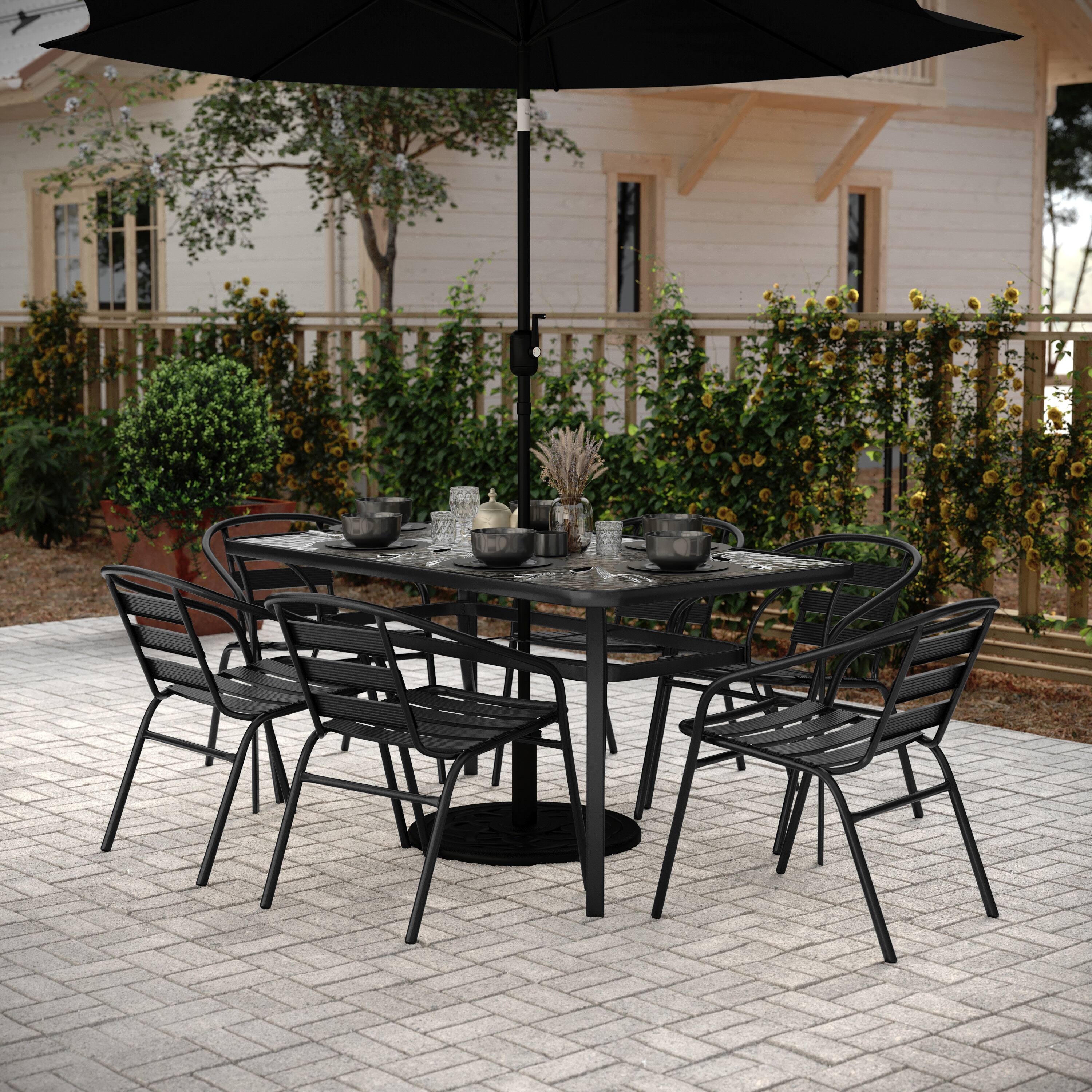 Angle. Flash Furniture - Lila 7 Piece Commercial Outdoor Patio Dining Set with 60" Tempered Glass Patio Table with Umbrella Hole and 6 Black Trip - Black.