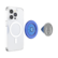 The image shows a white cell phone with a PopSockets case attached to it. The case is blue and has a circular design. The phone is placed on a black background, and the PopSockets case is shown in two different positions, one on the phone and the other detached.