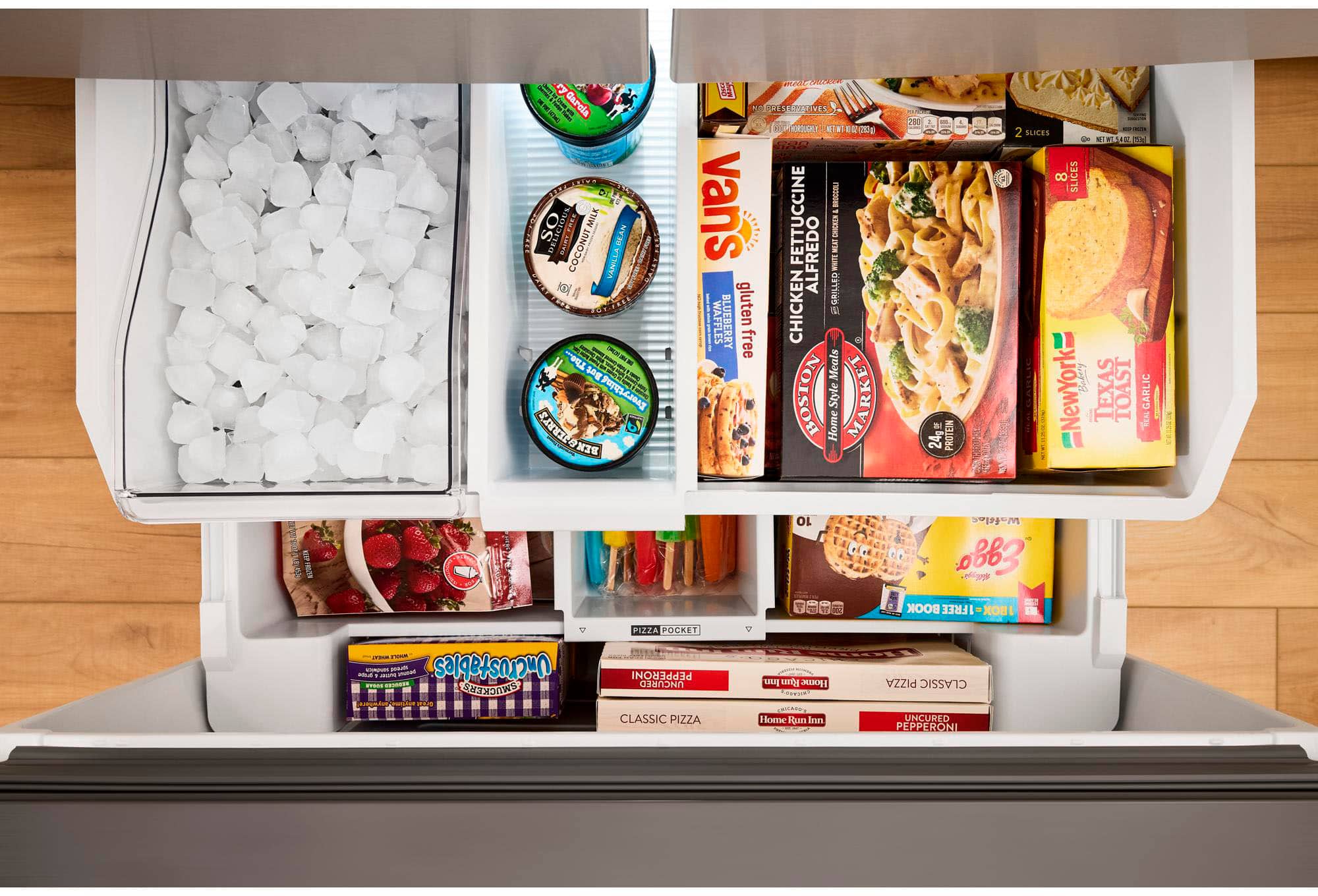 The image shows a refrigerator with its door open, revealing a variety of food items inside. There are several bottles, including a carton of milk, a carton of coconut milk, and a carton of almond milk. There are also multiple ice cream containers, with one placed in the middle of the refrigerator and another towards the right side.
In addition to the bottles and ice cream, there are other food items in the refrigerator, such as a bowl located towards the left side and a broccoli placed in the middle. The refrigerator is filled with a diverse assortment of food, making it a well-stocked and convenient space for meal preparation and storage.