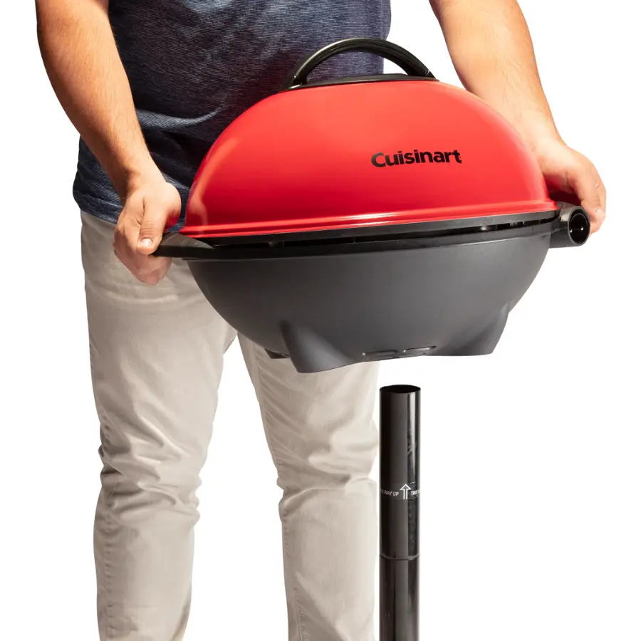 Cuisinart is the brand of the red and gray grill that the person is holding.